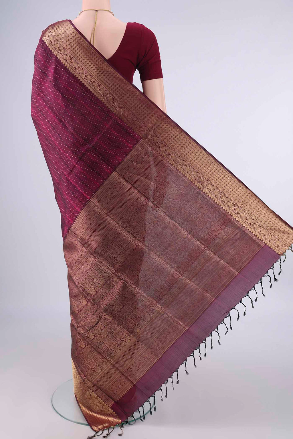 Flat view of Pure Silk Maroon Soft Saree with Jacquard With Zari Butta on the body and Zari And Thread Border. 