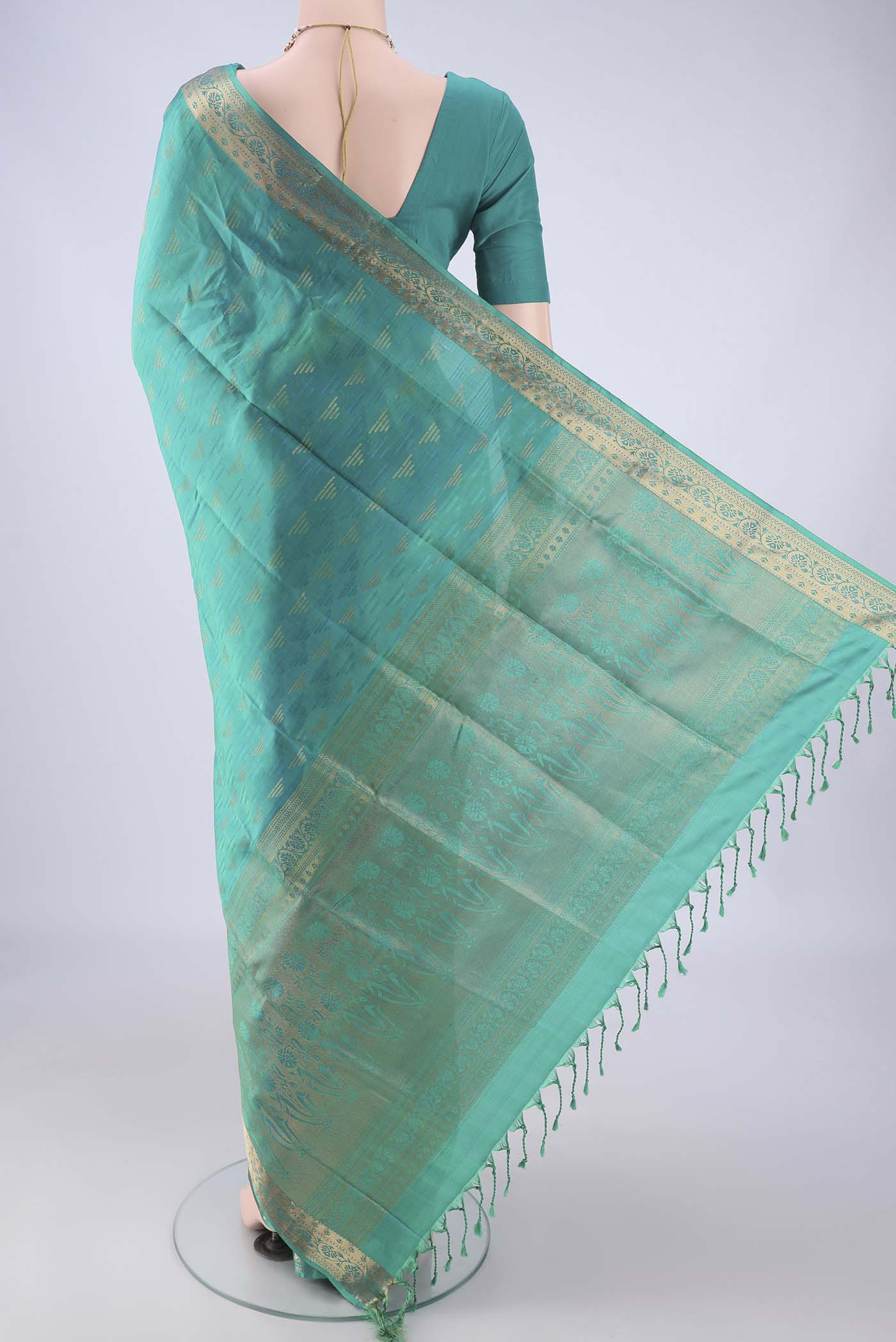 Flat view of Sea Green Soft Silk Saree with Jacquard With Zari Butta on the body and Thread Border. 