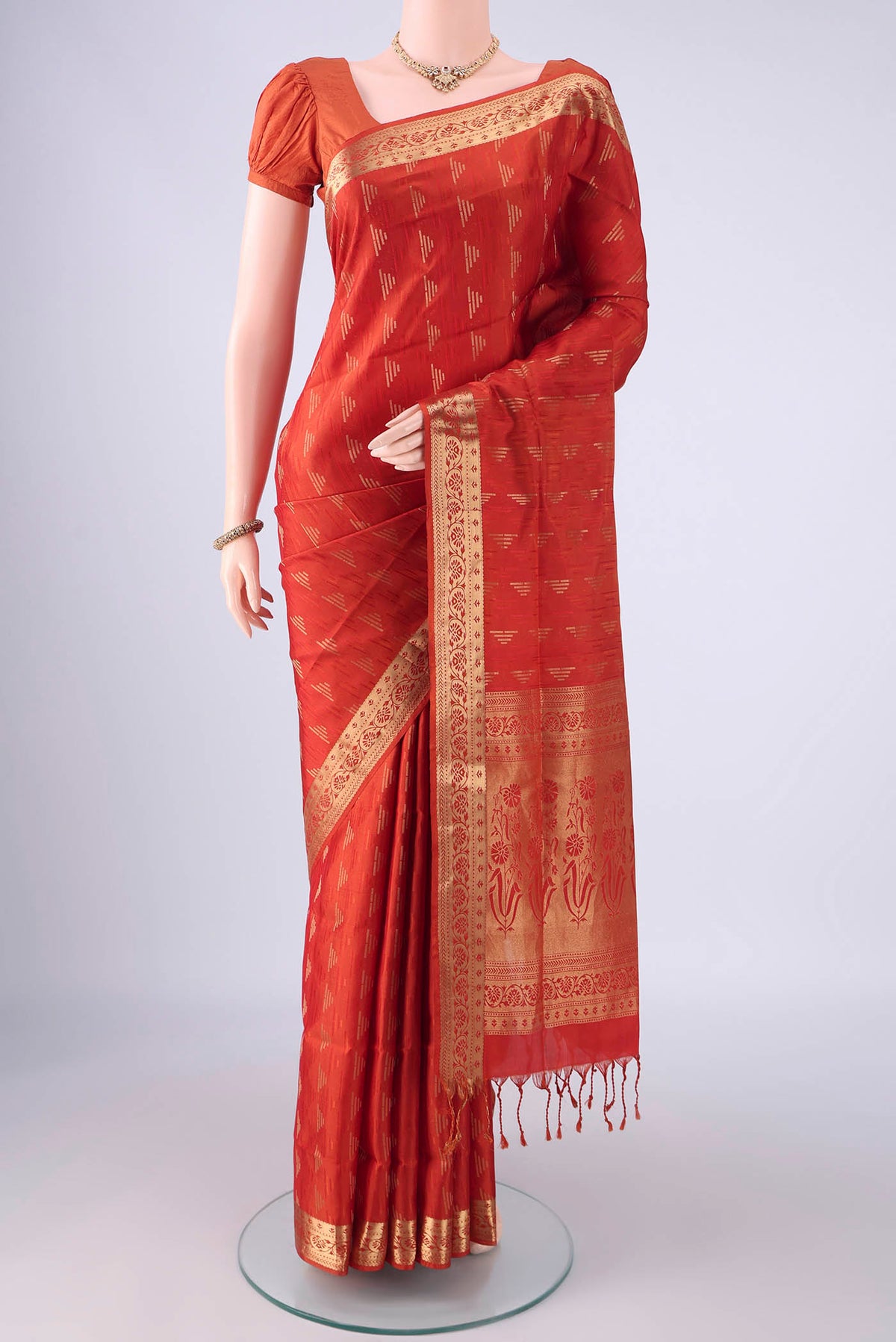Brick Orange Soft Silk Saree with Jacquard With Zari Butta on the body and Zari Border.  displayed on a mannequin
