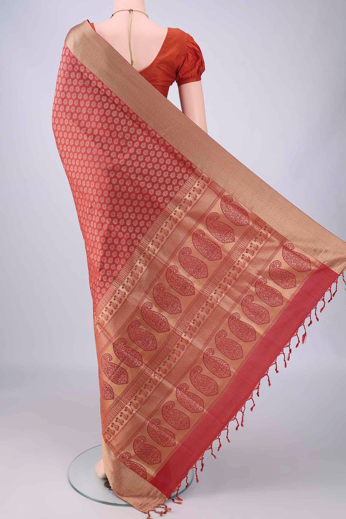 Flat view of Rust Soft Silk Saree with Jacquard With Thread Butta on the body and Thread Border. 