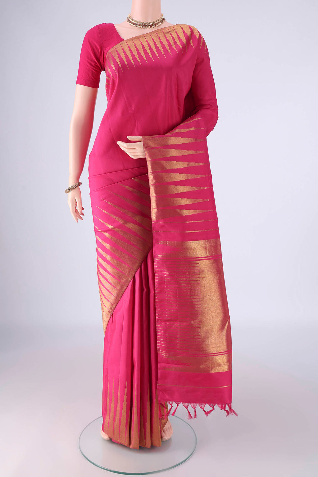 Pure Silk Pure Zari Rani Pink Kanchipuram Saree with Plain Body and Temple Border.  displayed on a mannequin