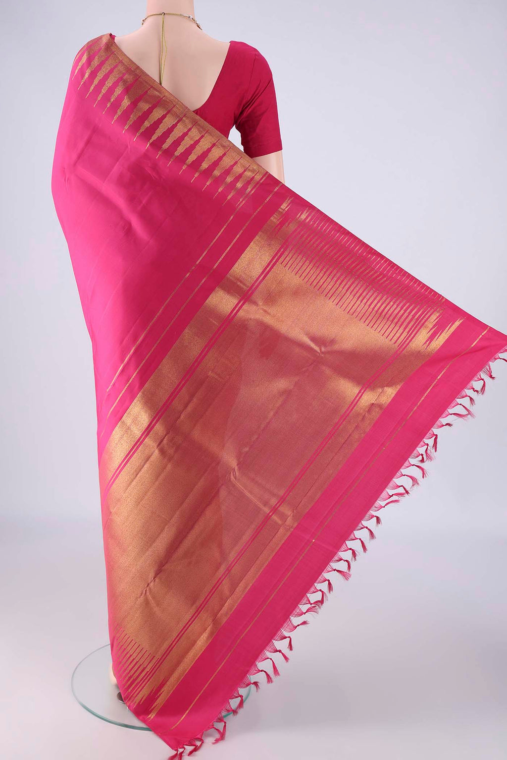 Flat view of Pure Silk Pure Zari Rani Pink Kanchipuram Saree with Plain Body and Temple Border. 