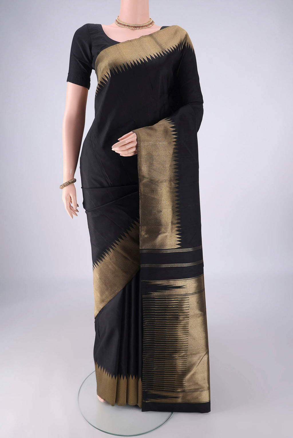 Pure Silk Pure Zari Black Kanchipuram Saree with Plain Body and Temple Border.  displayed on a mannequin