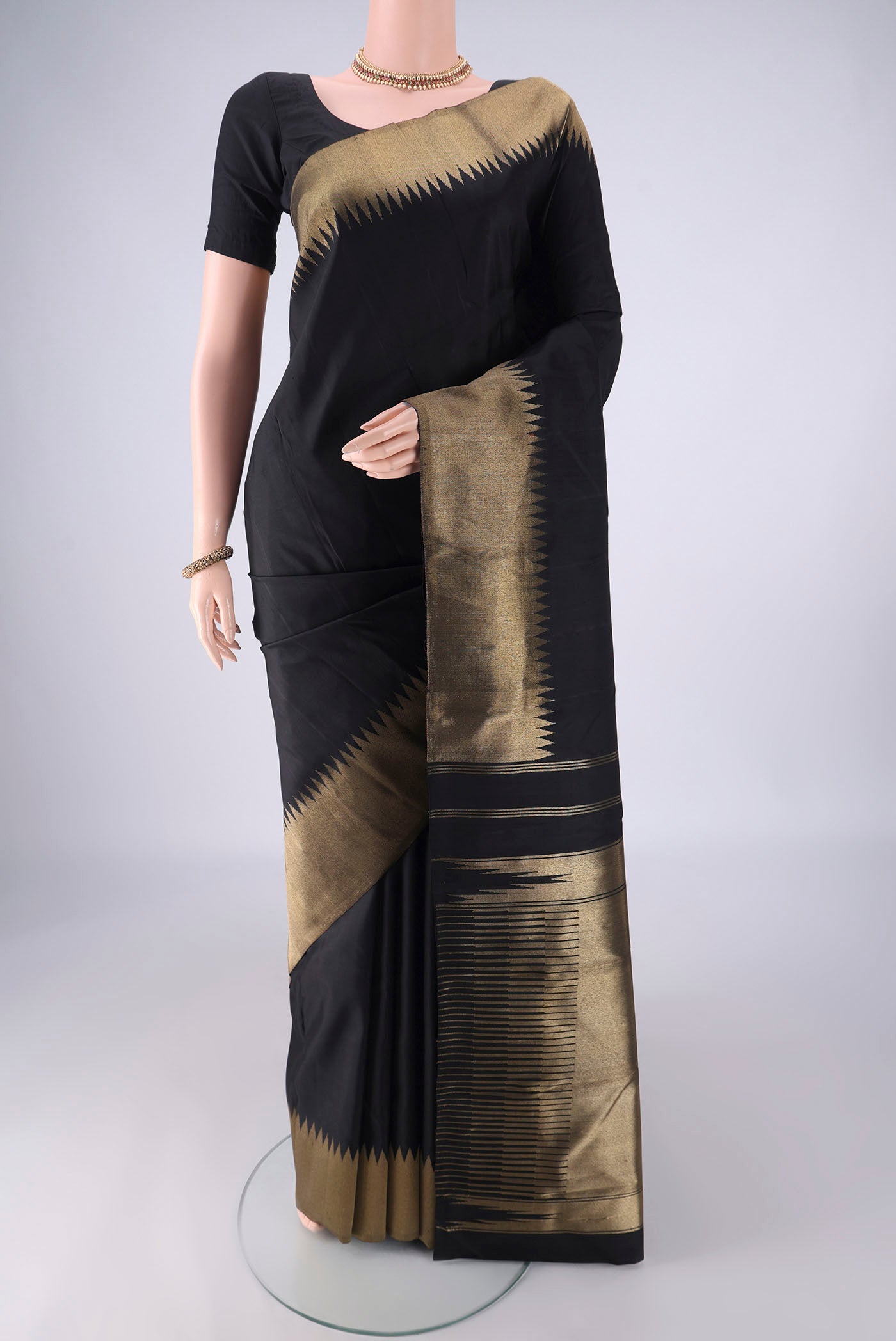 Pure Silk Pure Zari Black Kanchipuram Saree with Plain Body and Temple Border.  displayed on a mannequin