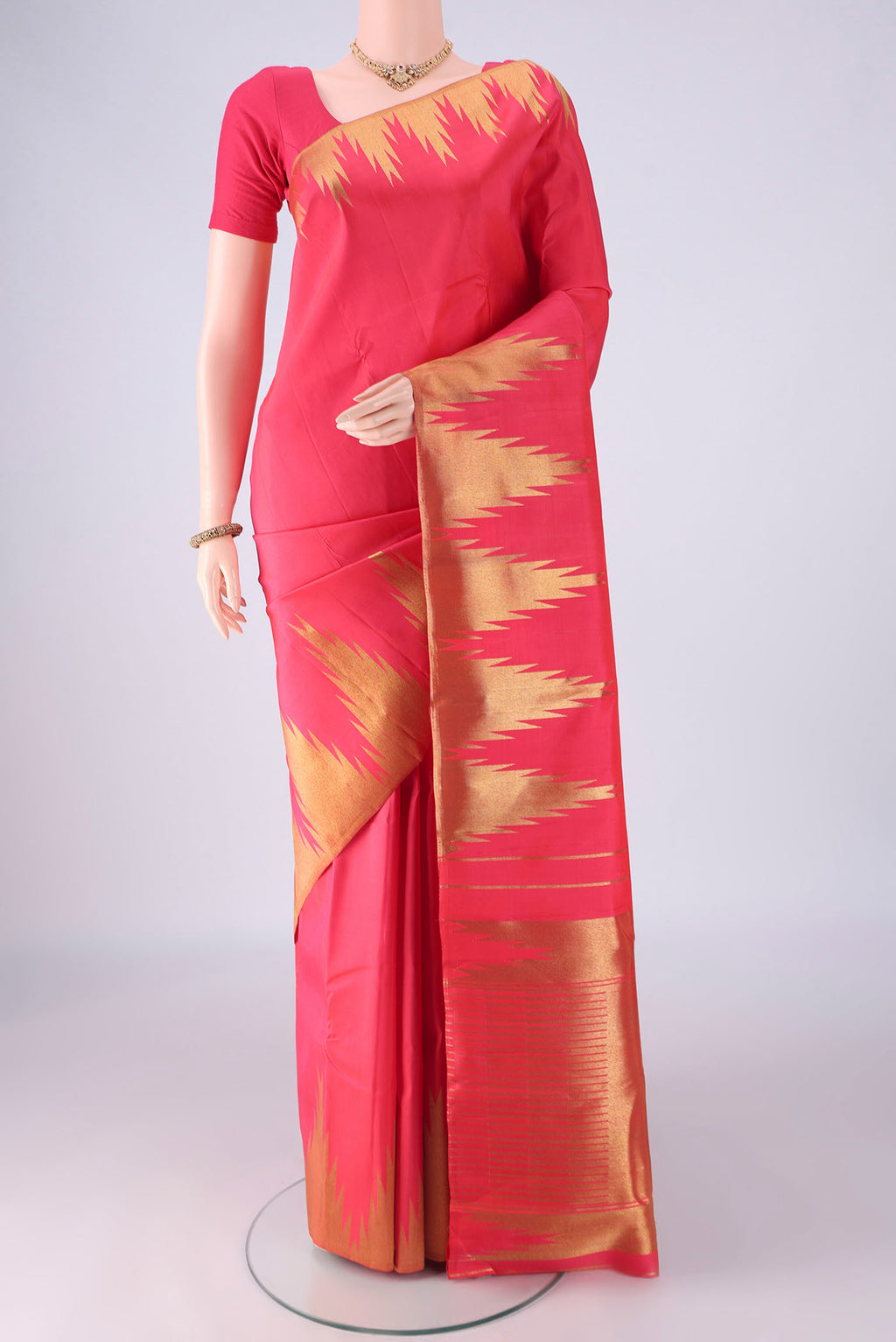 Pure Silk Pure Zari Dark Pink Kanchipuram Saree with Plain Body and Temple Border.  displayed on a mannequin
