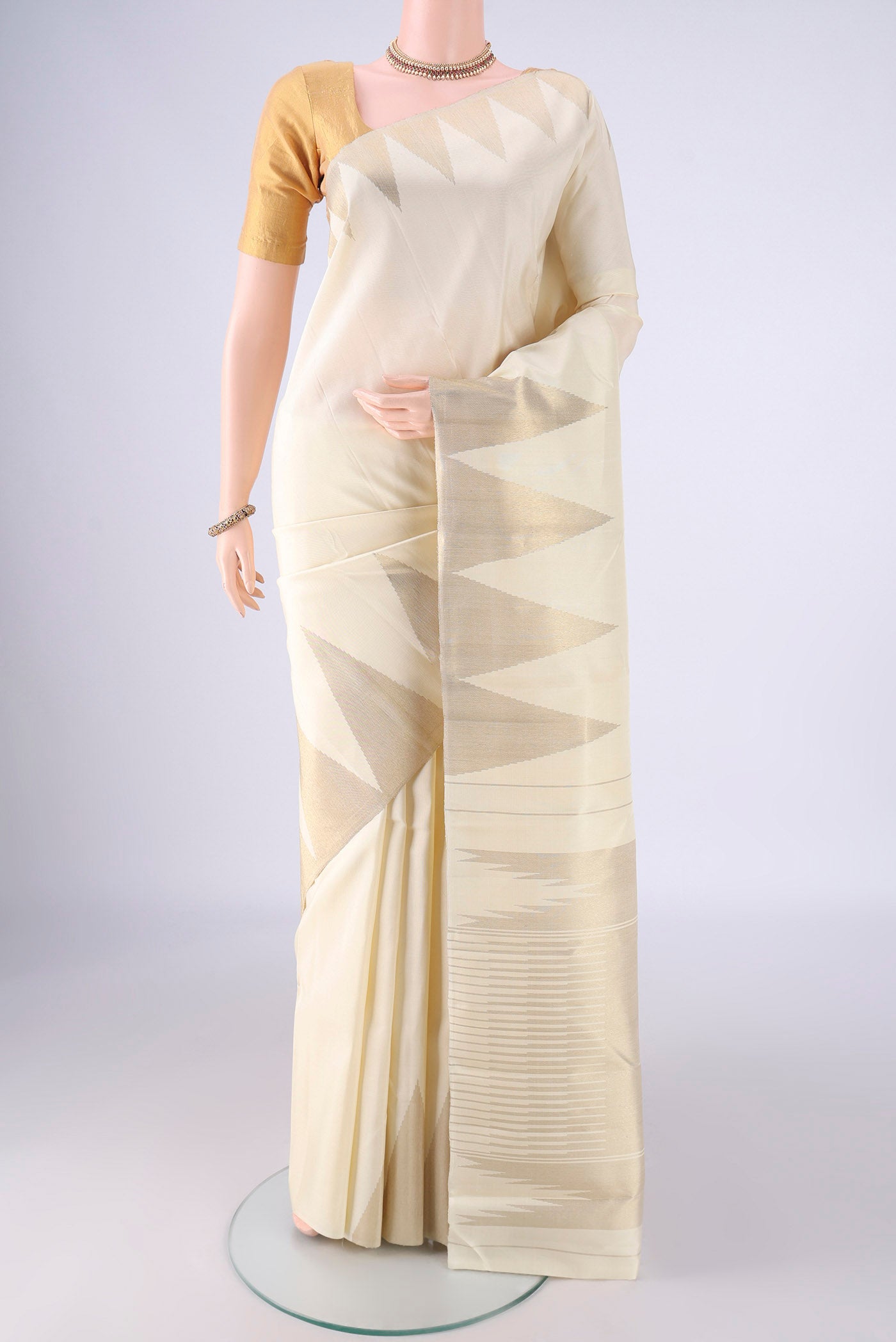 Pure Silk Pure Zari Off White Kanchipuram Saree with Plain Body and Temple Border.  displayed on a mannequin