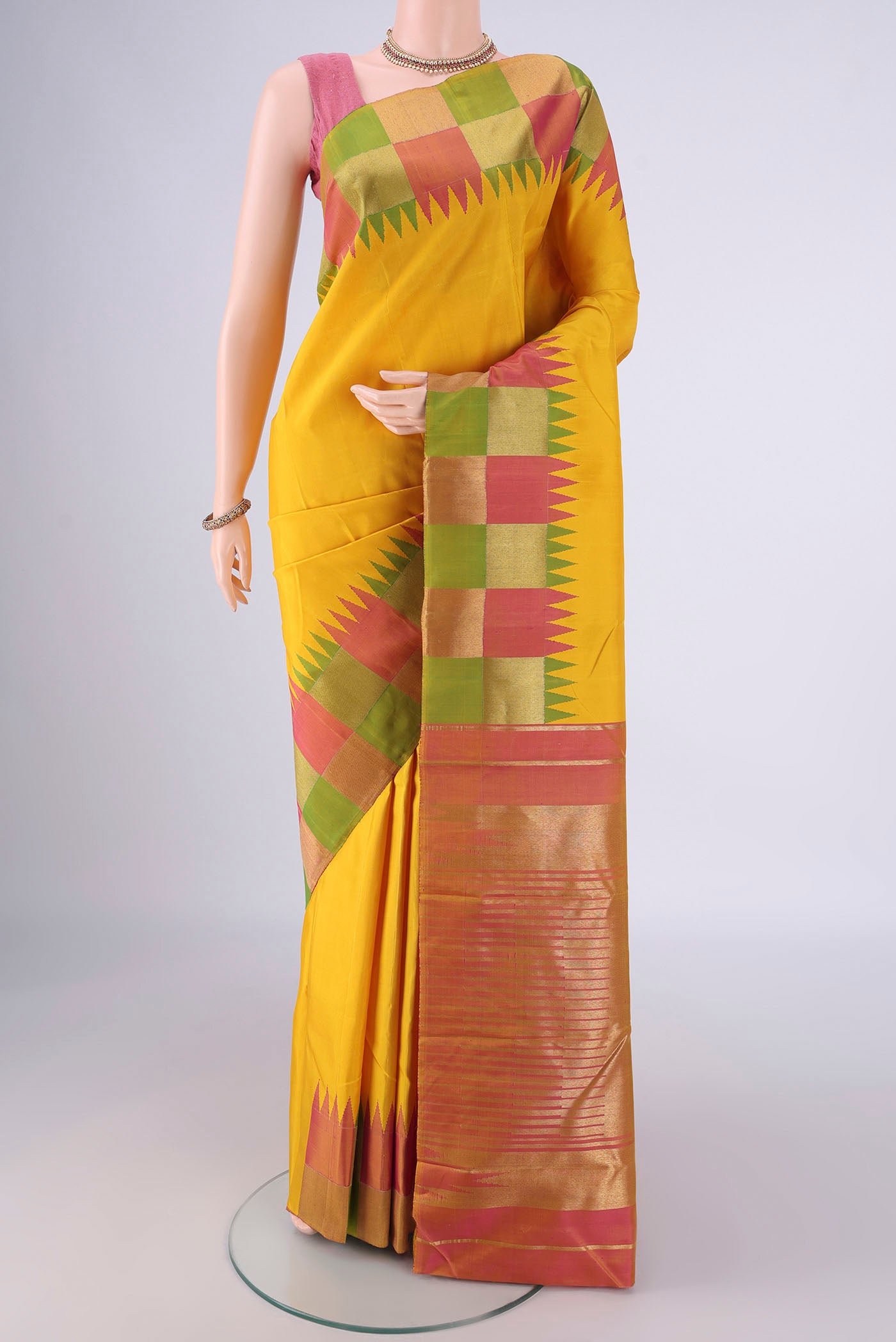 Lemon Yellow Kanjivaram Silk Saree with Plain Body and Temple Border.  displayed on a mannequin