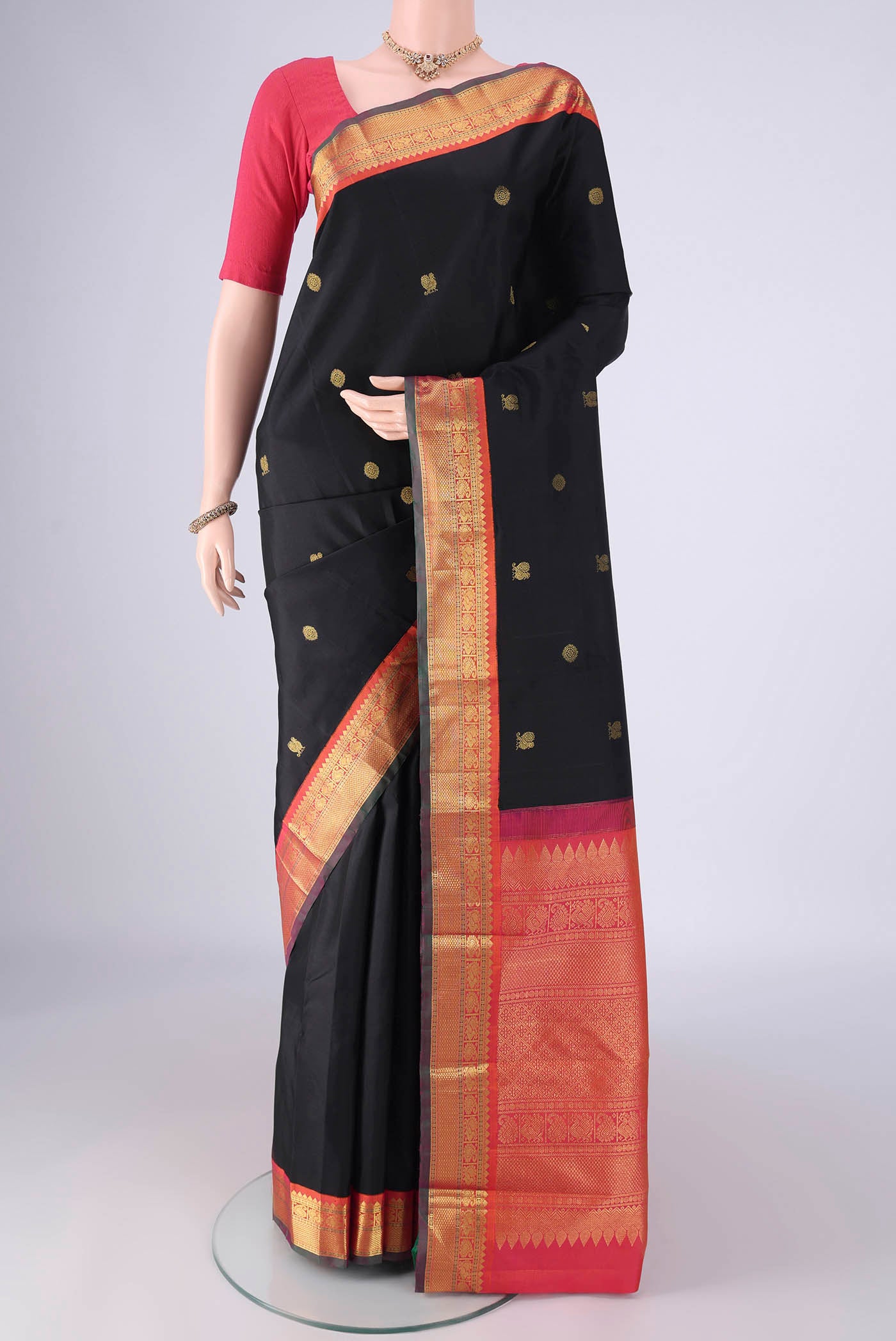 Black Kanjivaram Silk Saree with Zari Butta on the body and Zari Border.  displayed on a mannequin