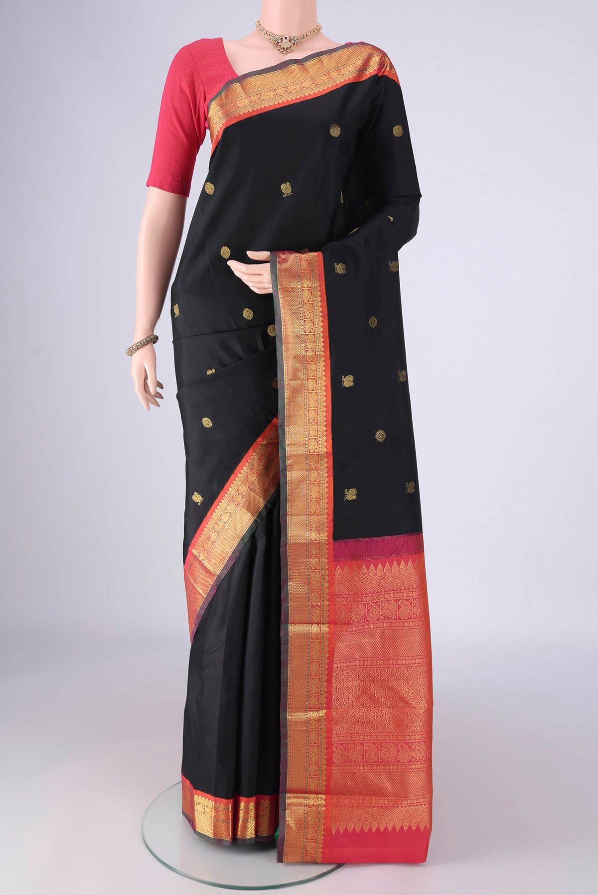 Black Kanjivaram Silk Saree with Zari Butta on the body and Zari Border.  displayed on a mannequin