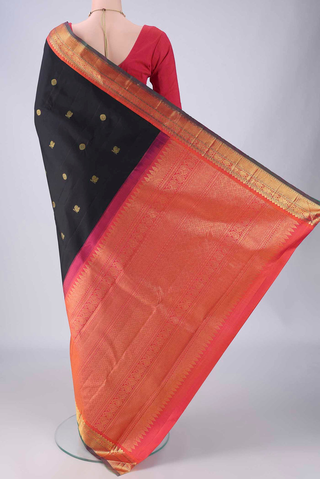 Flat view of Black Kanjivaram Silk Saree with Zari Butta on the body and Zari Border. 