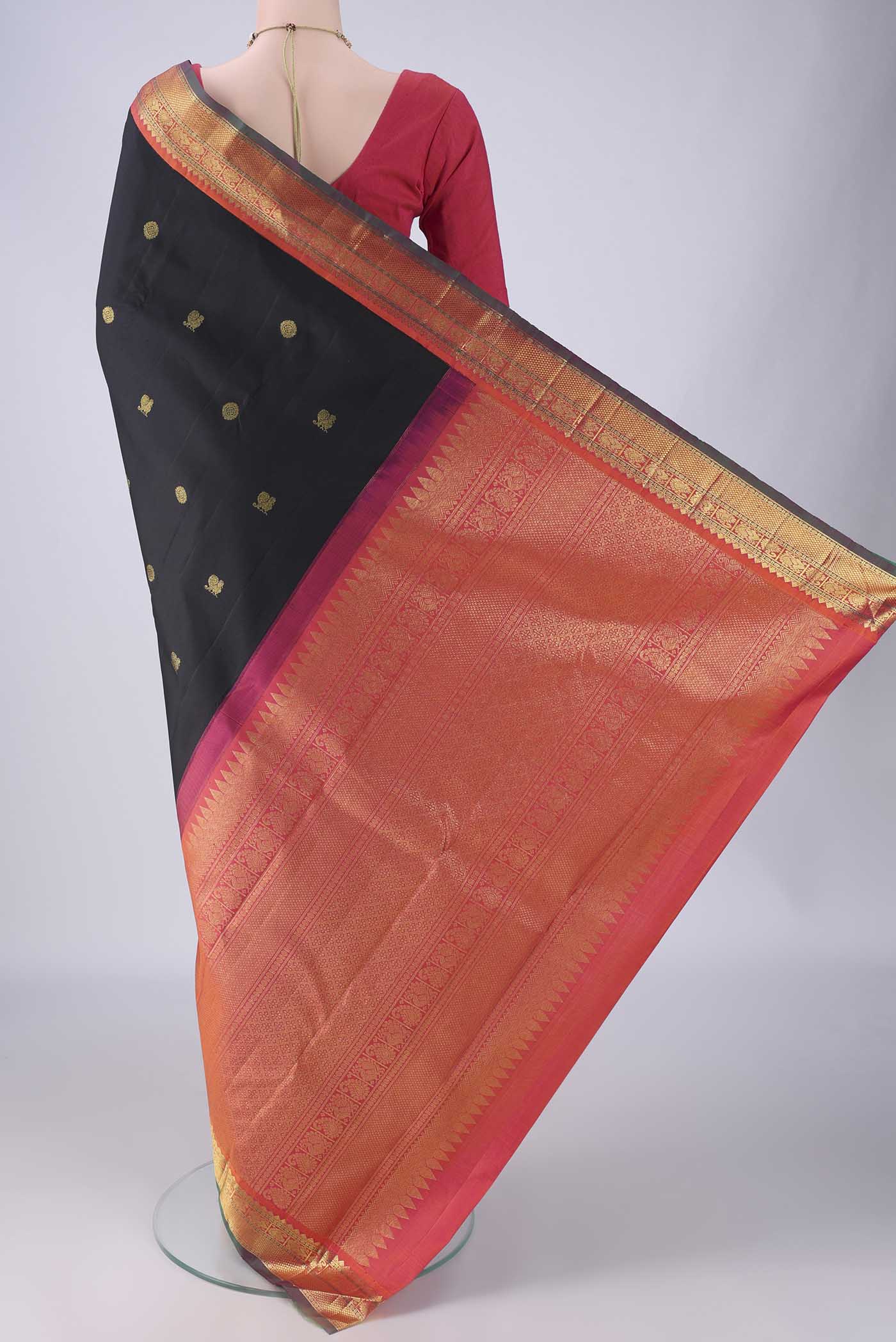 Flat view of Black Kanjivaram Silk Saree with Zari Butta on the body and Zari Border. 
