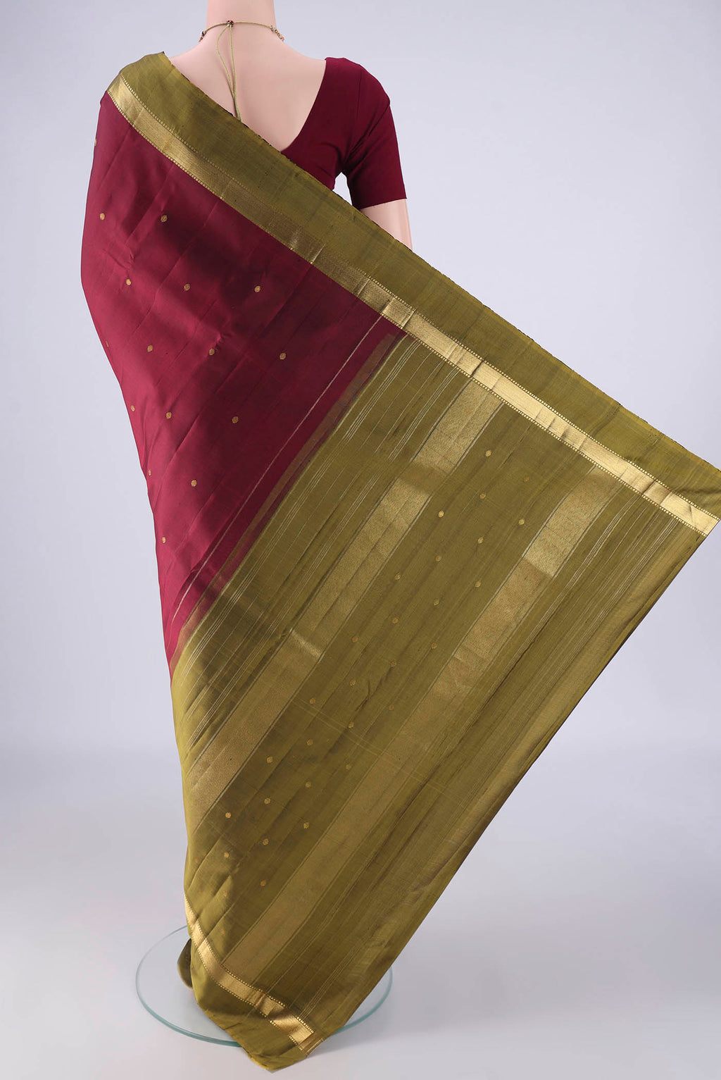 Flat view of Maroon Kanchipuram Silk Saree with Zari Butta on the body and Zari Border. 