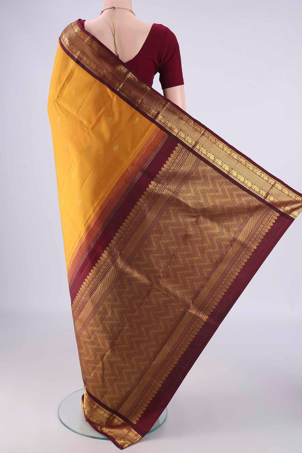Flat view of Mustard Kanchipuram Silk Saree with Zari Butta on the body and Zari Border. 