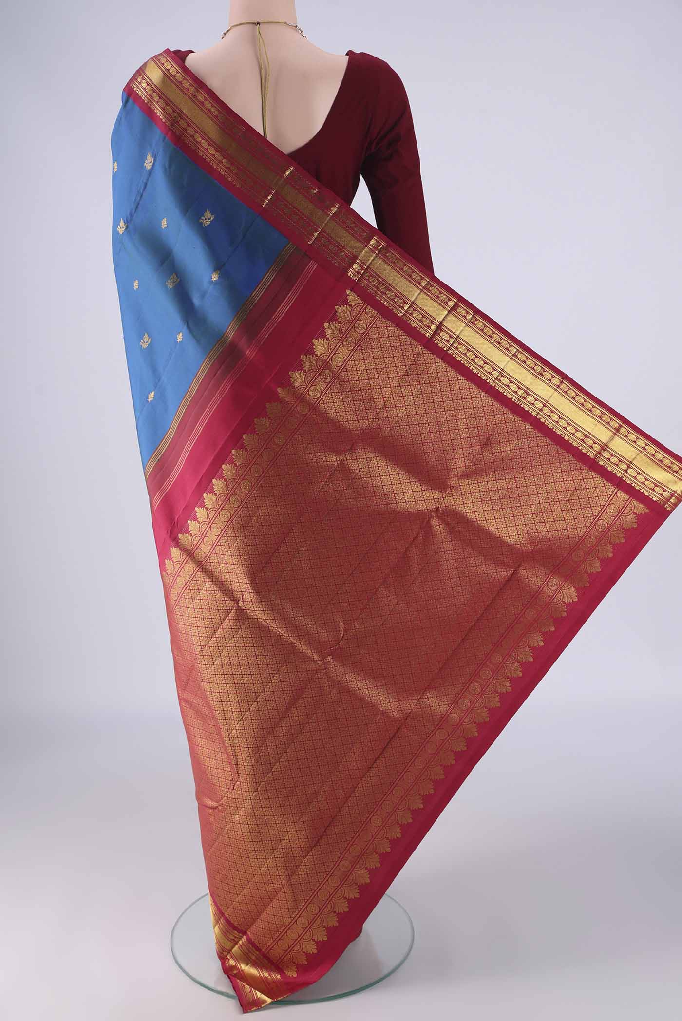 Flat view of Blue Kanchipuram Silk Saree with Zari Butta on the body and Zari Border. 