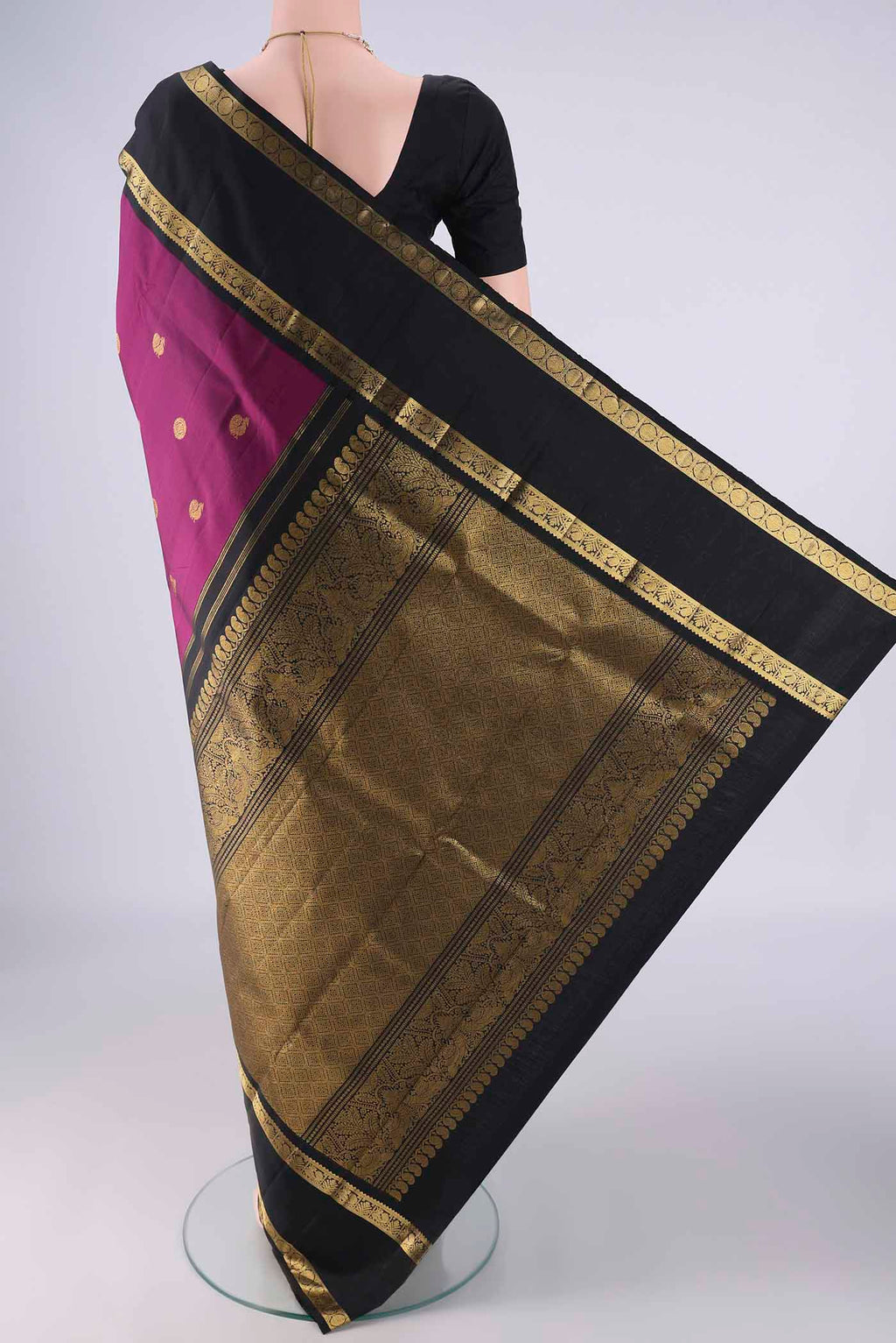 Flat view of Magenta Kanchipuram Silk Saree with Zari Butta on the body and Zari Border. 