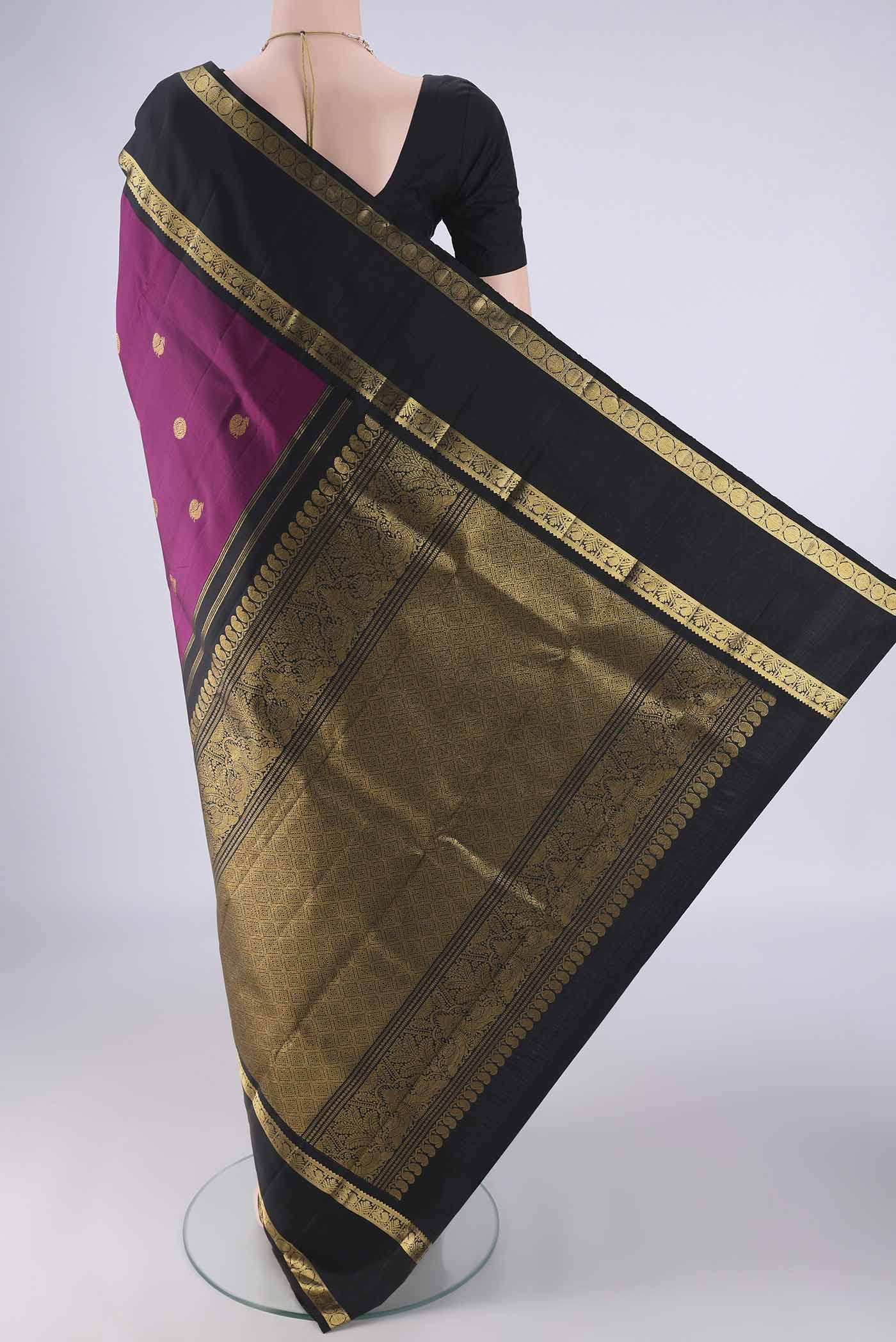 Flat view of Magenta Kanchipuram Silk Saree with Zari Butta on the body and Zari Border. 