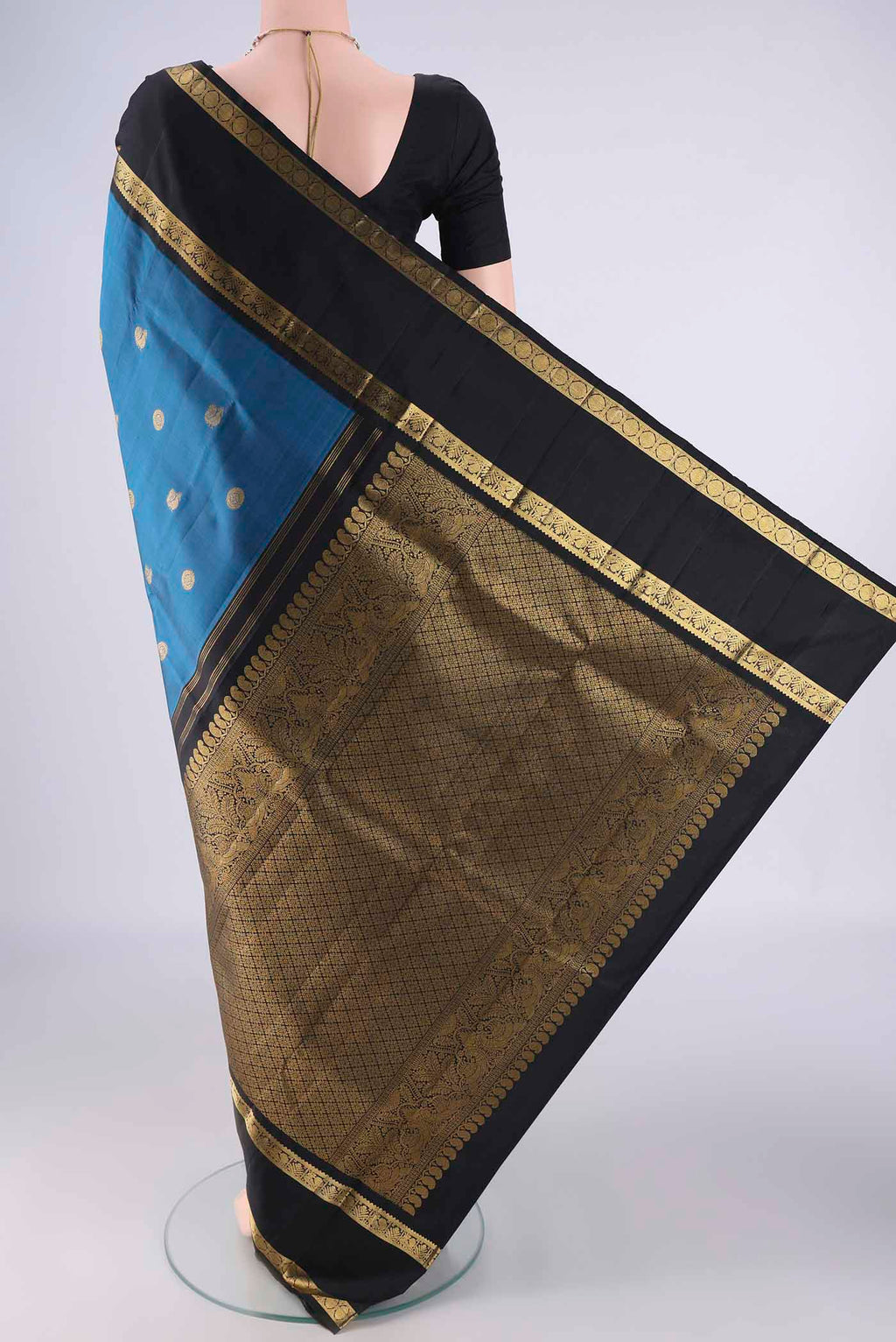 Flat view of Blue Kanchipuram Silk Saree with Zari Butta on the body and Zari Border. 