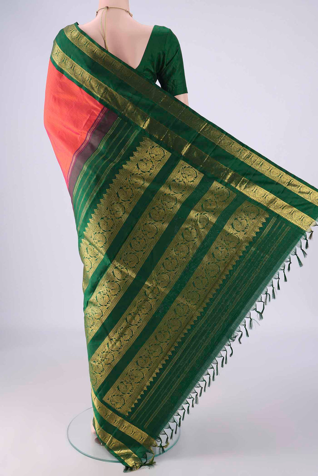 Flat view of Brick Orange Kanjivaram Silk Saree with Plain Body and Zari Border. 
