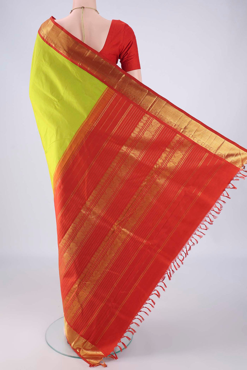 Flat view of Parrot Green Kanjivaram Silk Saree with Plain Body and Zari Border. 