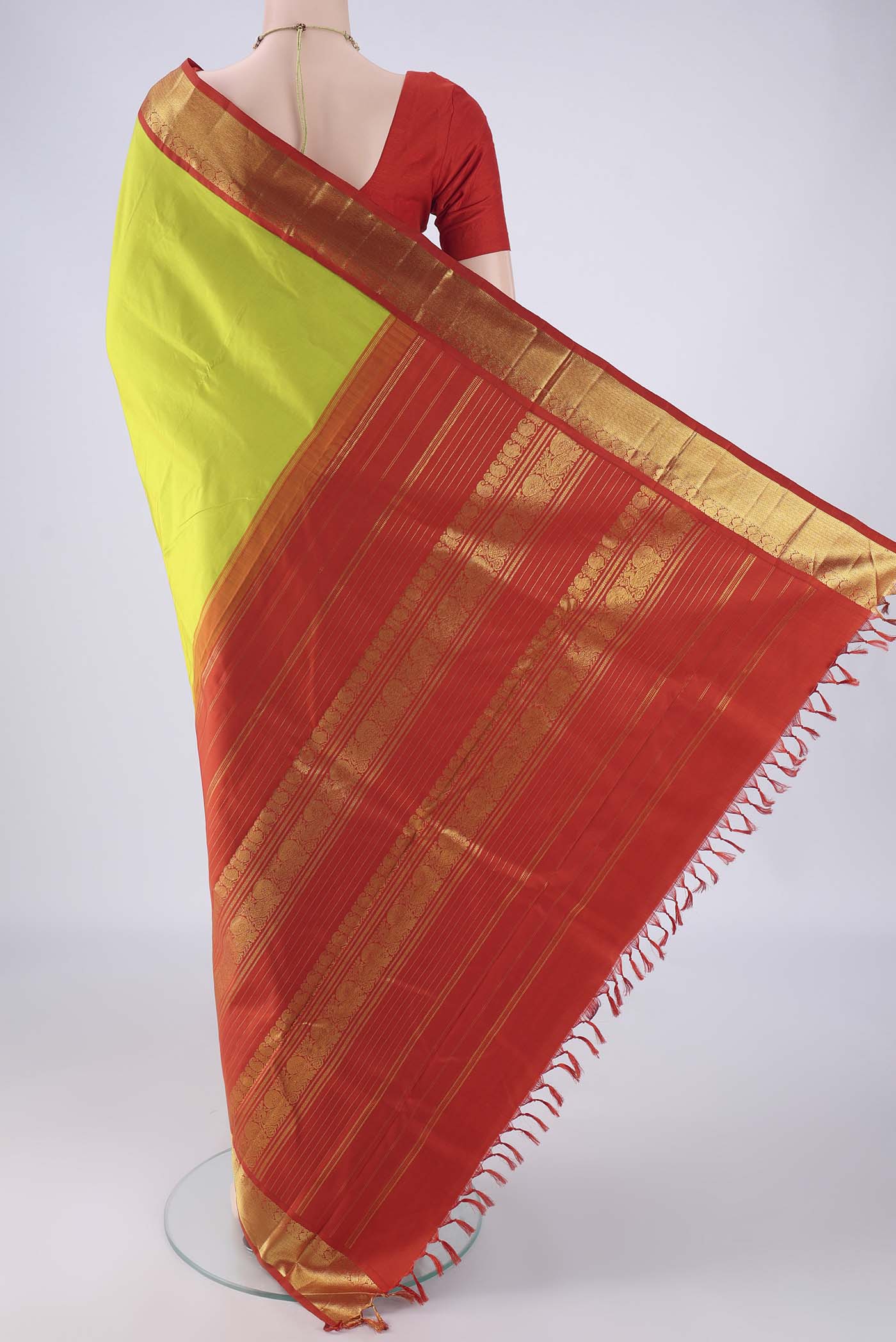 Flat view of Parrot Green Kanjivaram Silk Saree with Plain Body and Zari Border. 