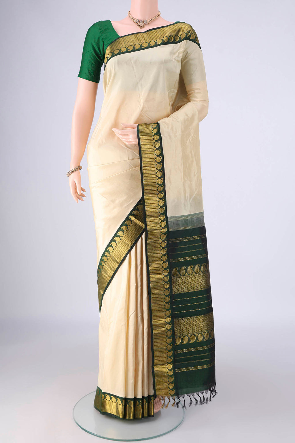 Off White Kanjivaram Silk Saree with Plain Body and Zari Border.  displayed on a mannequin