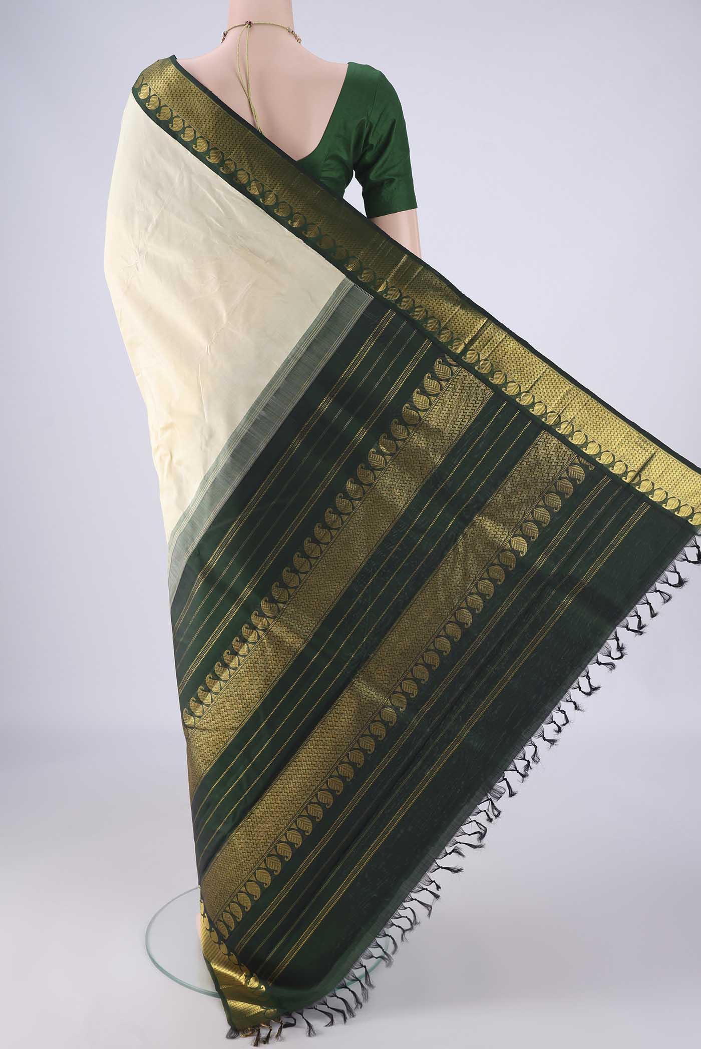 Flat view of Off White Kanjivaram Silk Saree with Plain Body and Zari Border. 