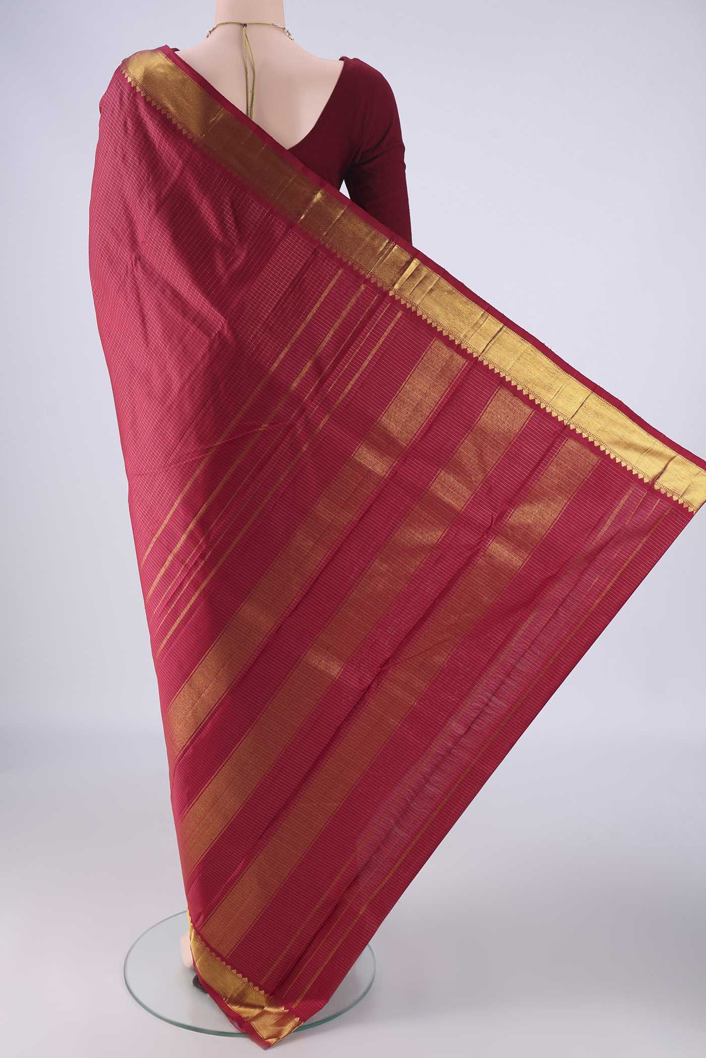 Flat view of Deep Red Kanchipuram Silk Saree with Checked design on the body and Zari Border. 