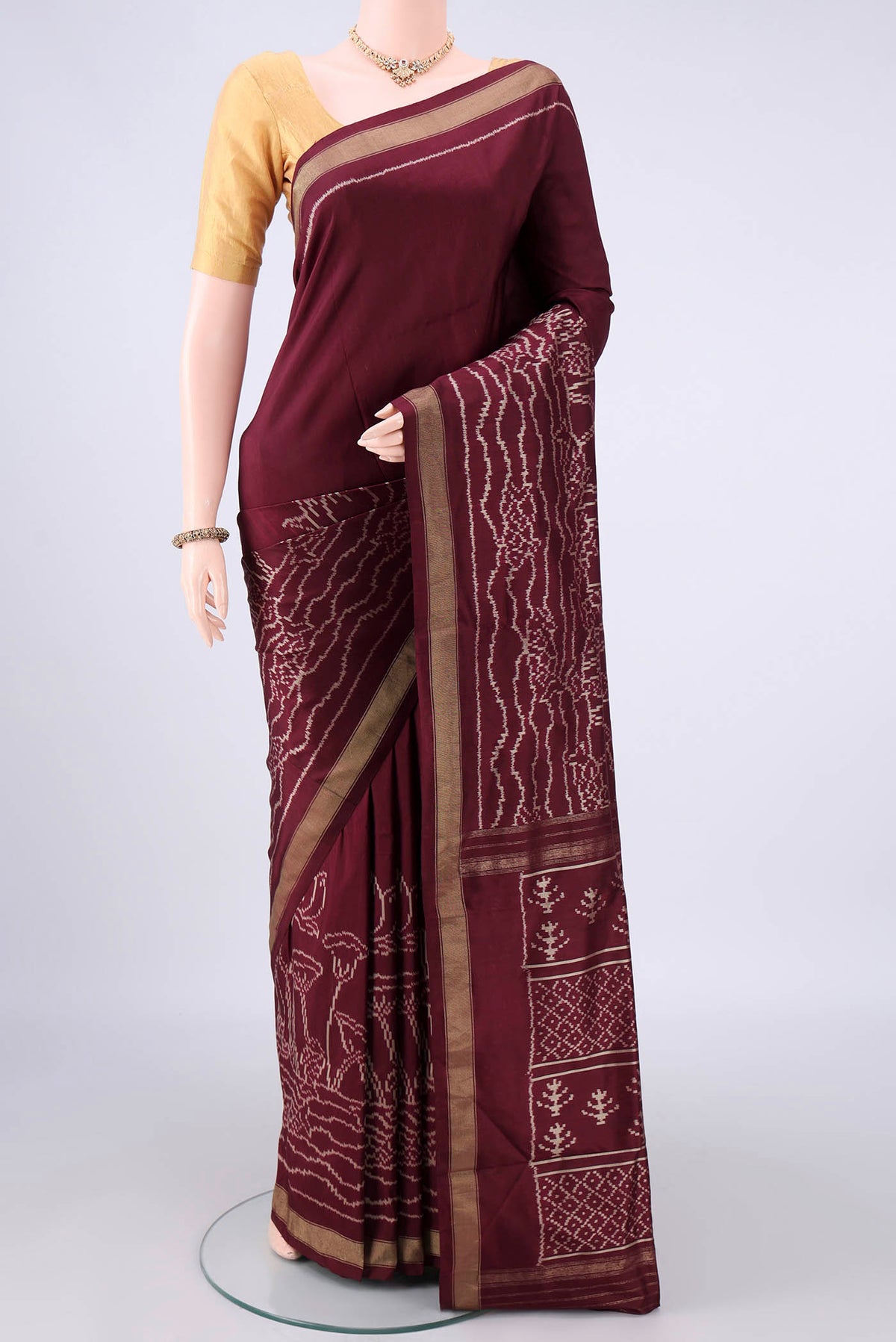 Pure Silk Brown Pochampally Saree with Pure Ikat on the body and Zari Border.  displayed on a mannequin