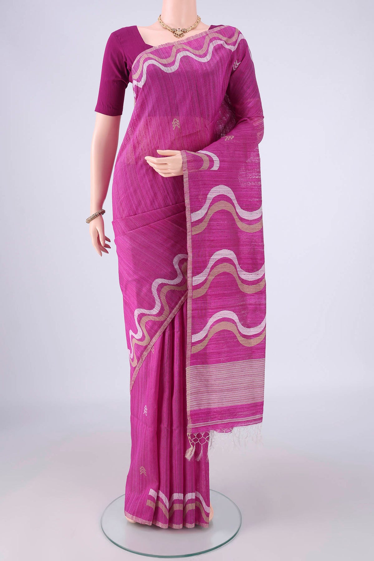 Magenta Tussar Silk Saree with Plain Body and Fancy Border.  displayed on a mannequin