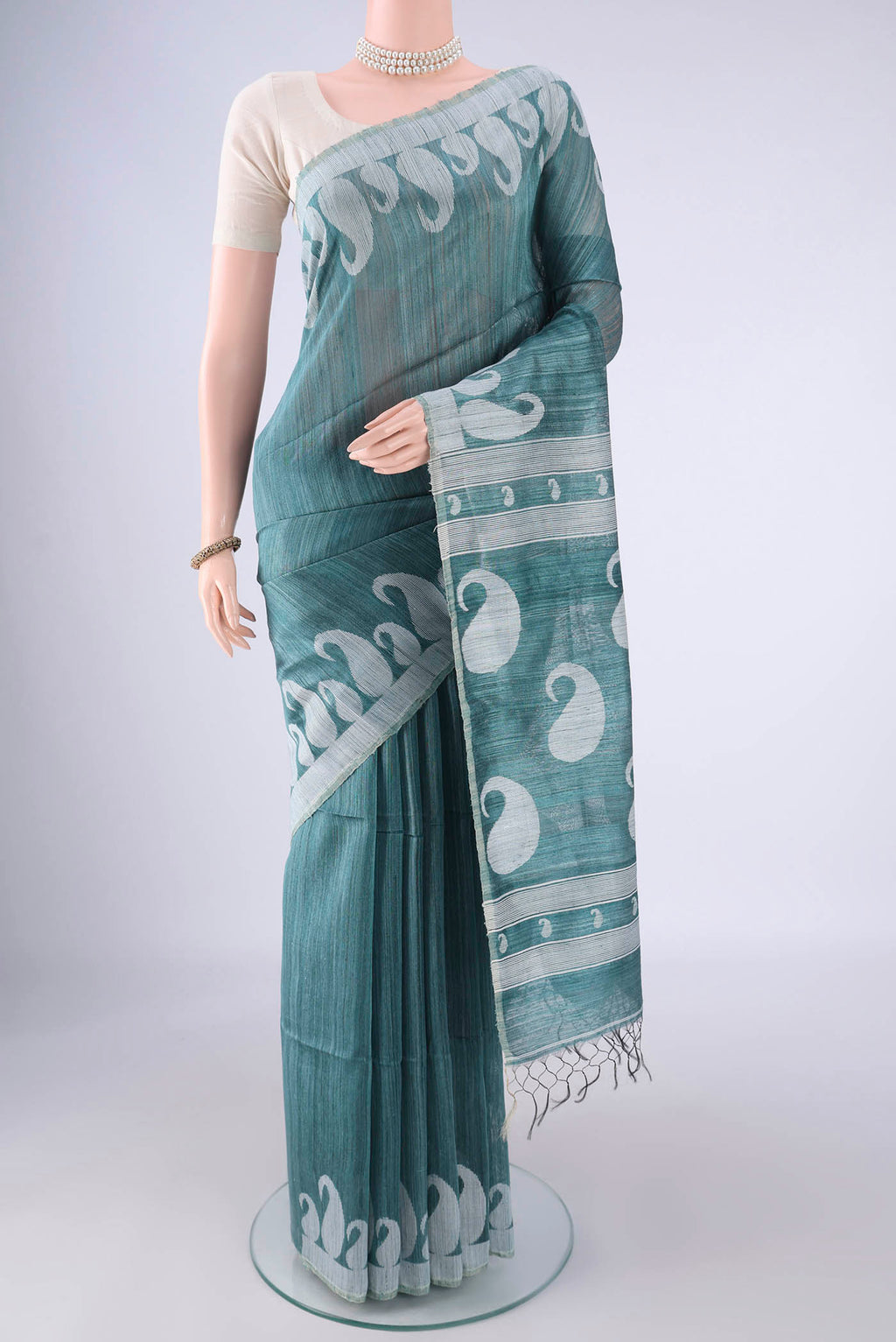 Maya Blue Jute Silk Saree with Plain Body and Thread Border.  displayed on a mannequin
