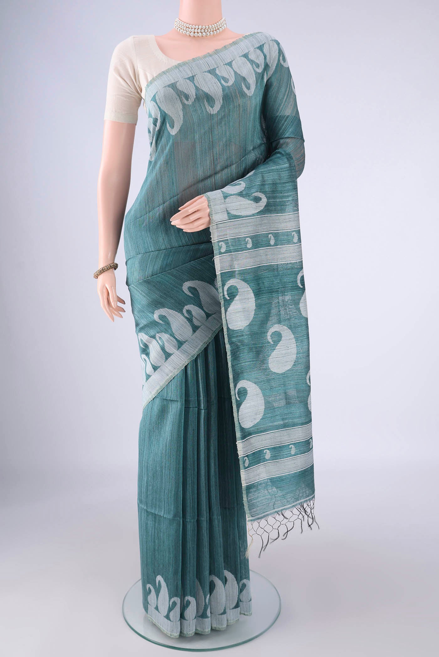 Maya Blue Jute Silk Saree with Plain Body and Thread Border.  displayed on a mannequin