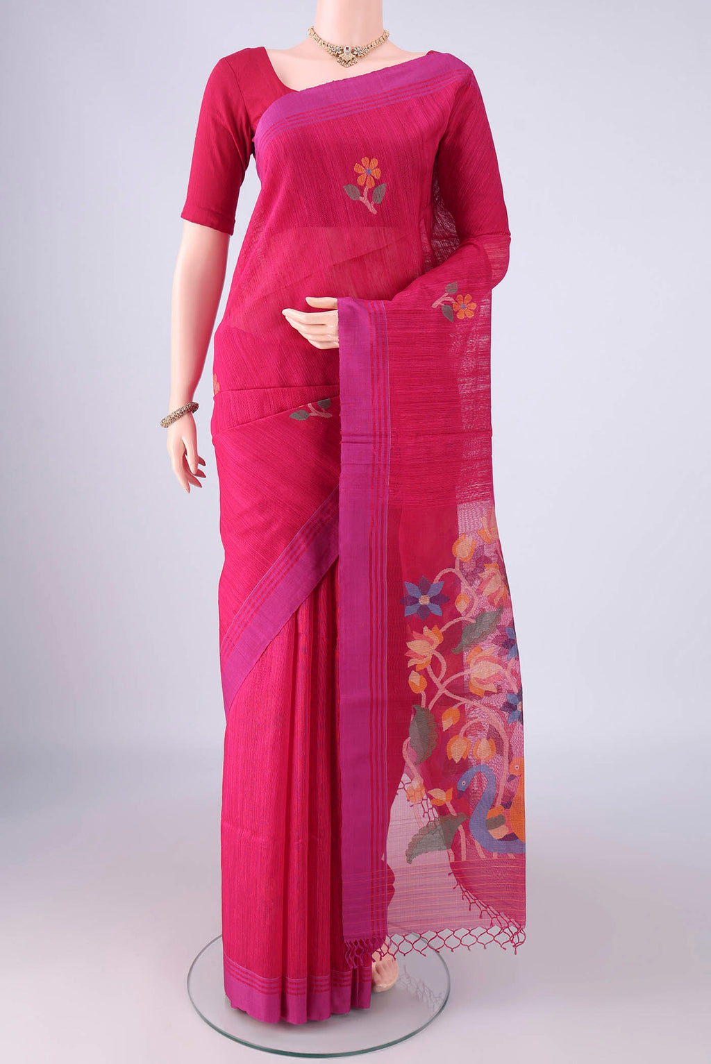 Rani Pink Jute Silk Saree with Thread Butta on the body and Plain Border.  displayed on a mannequin