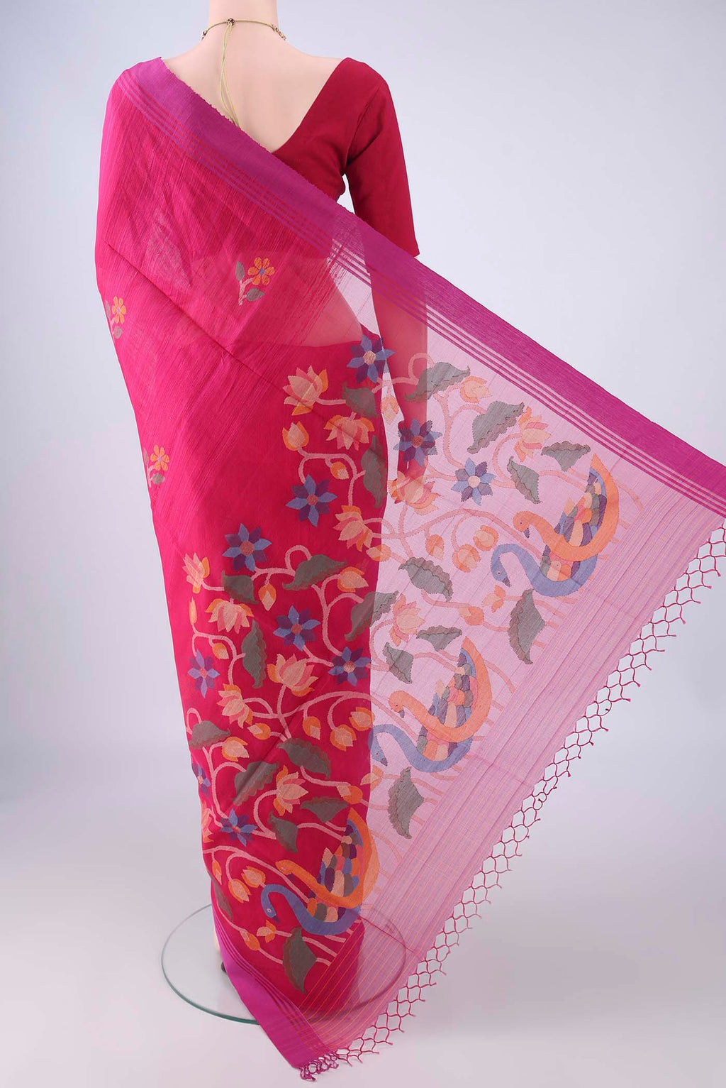 Flat view of Rani Pink Jute Silk Saree with Thread Butta on the body and Plain Border. 