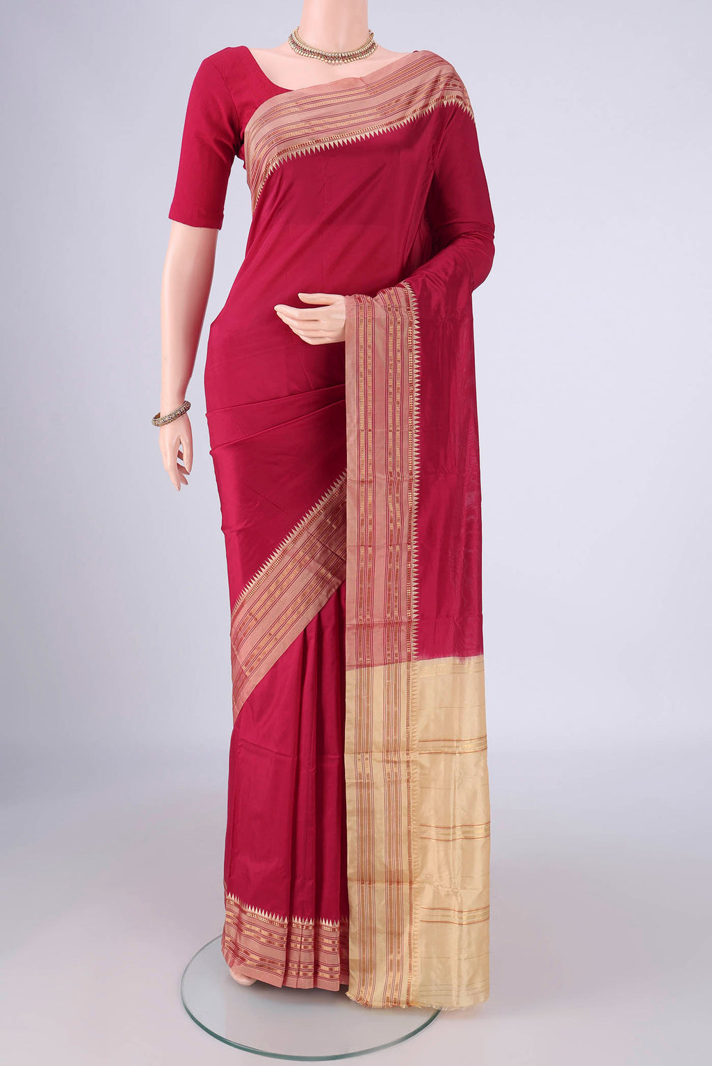 Maroon Narayanpet Silk Saree with Printed design on the body and Zari Border.  displayed on a mannequin