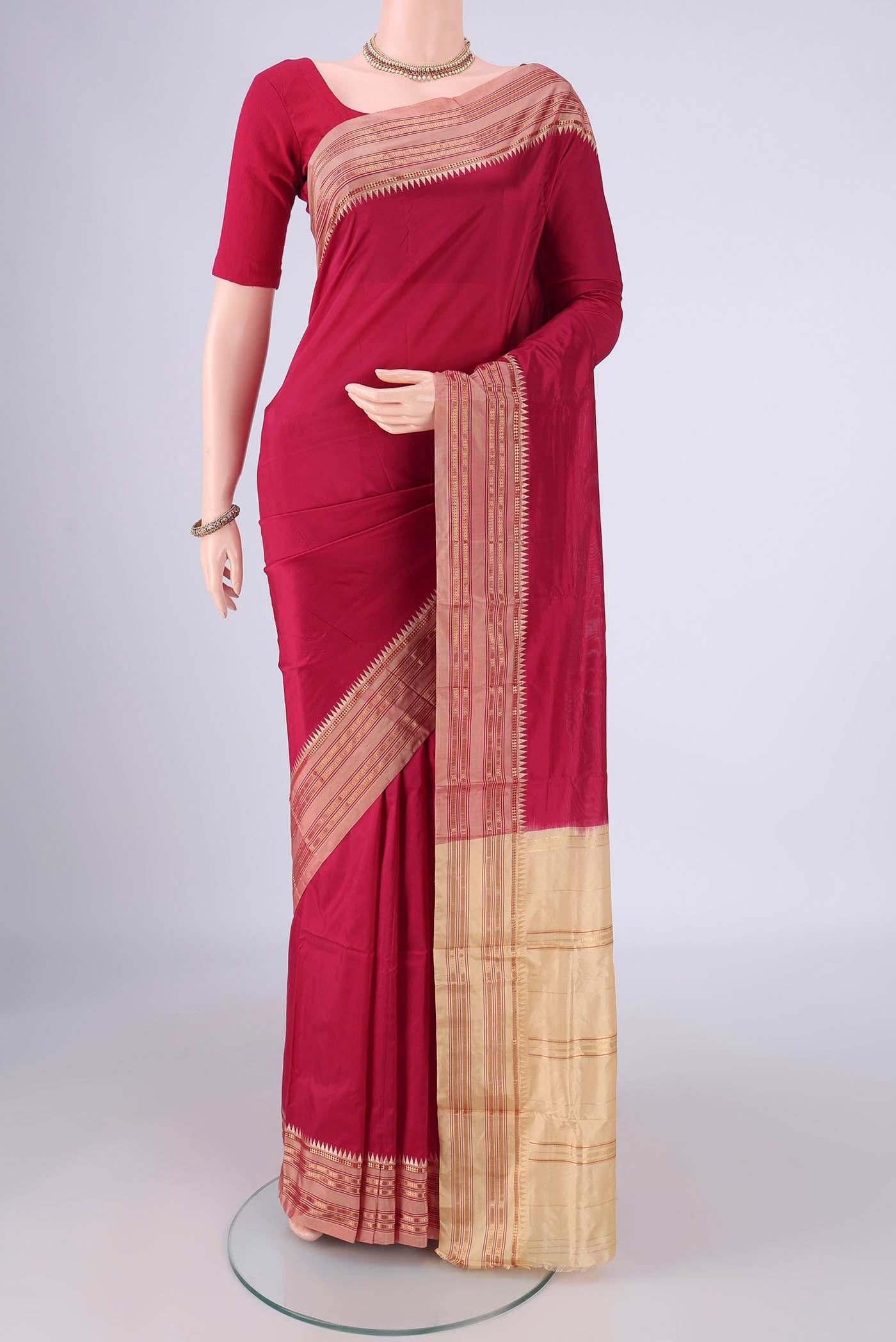 Maroon Narayanpet Silk Saree with Printed design on the body and Zari Border.  displayed on a mannequin