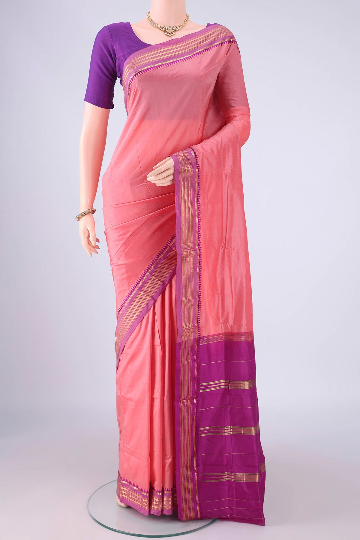 Peach Narayanpet Silk Saree with Plain Body and Zari Border.  displayed on a mannequin