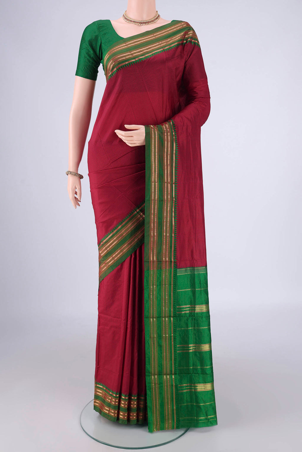 Maroon Narayanpet Silk Saree with Checked design on the body and Zari Border.  displayed on a mannequin