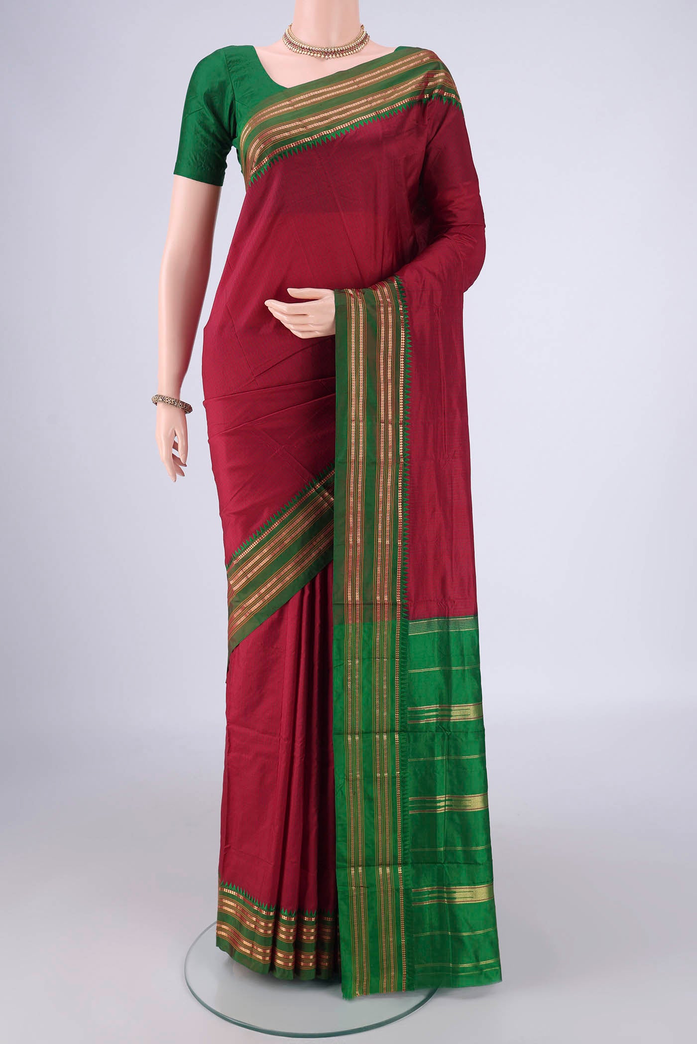 Maroon Narayanpet Silk Saree with Checked design on the body and Zari Border.  displayed on a mannequin