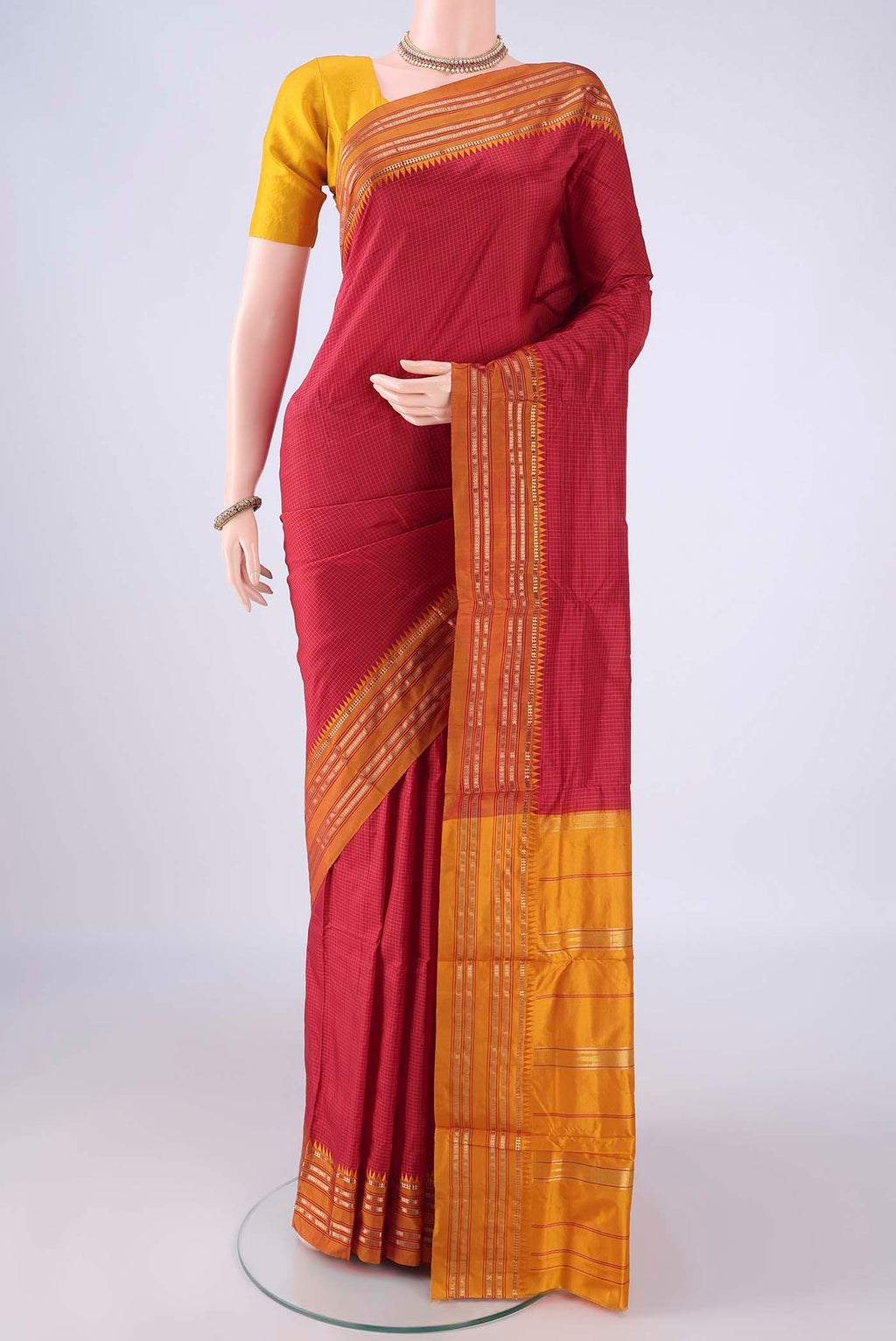 Red Narayanpet Silk Saree with Checked design on the body and Zari Border.  displayed on a mannequin