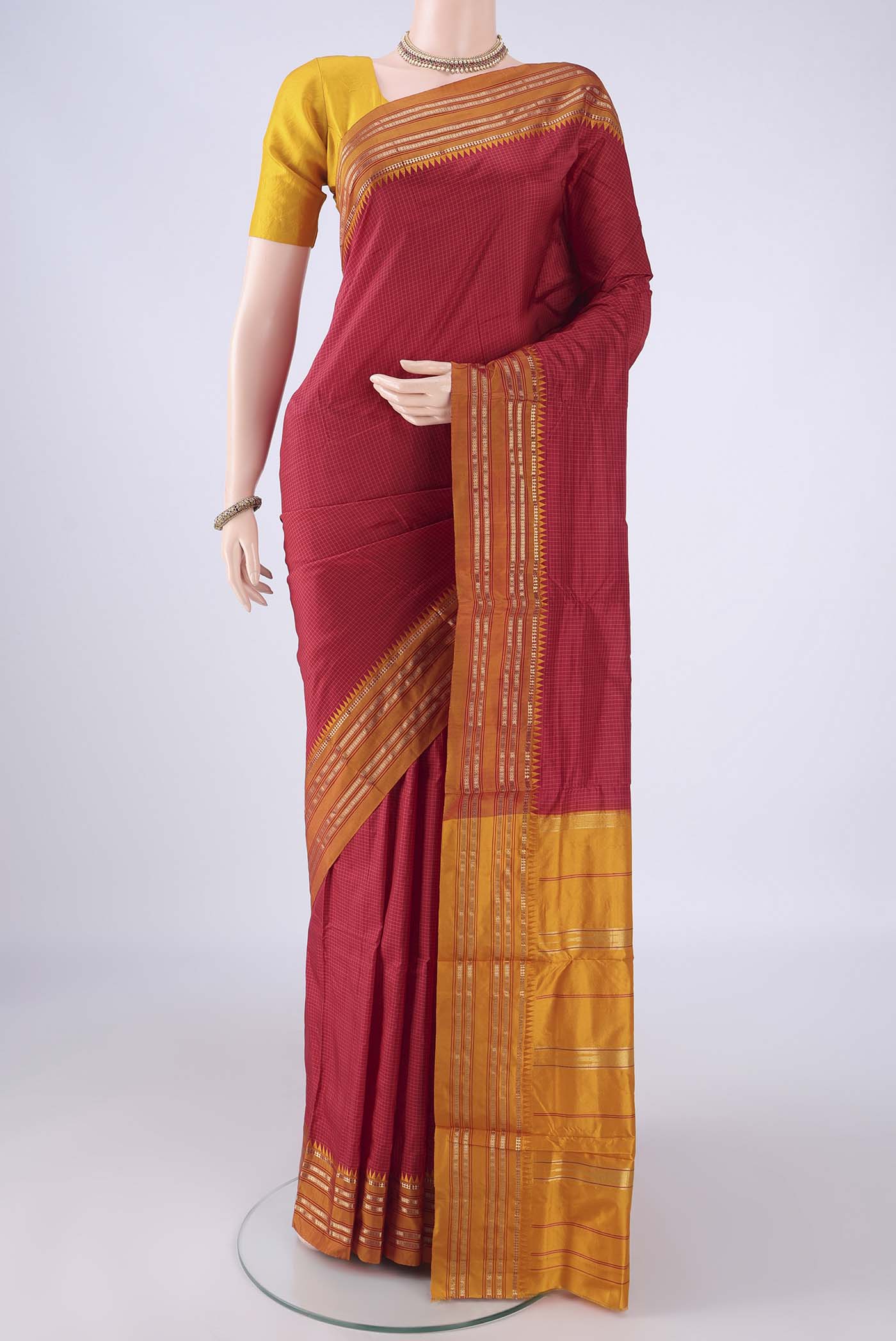 Red Narayanpet Silk Saree with Checked design on the body and Zari Border.  displayed on a mannequin
