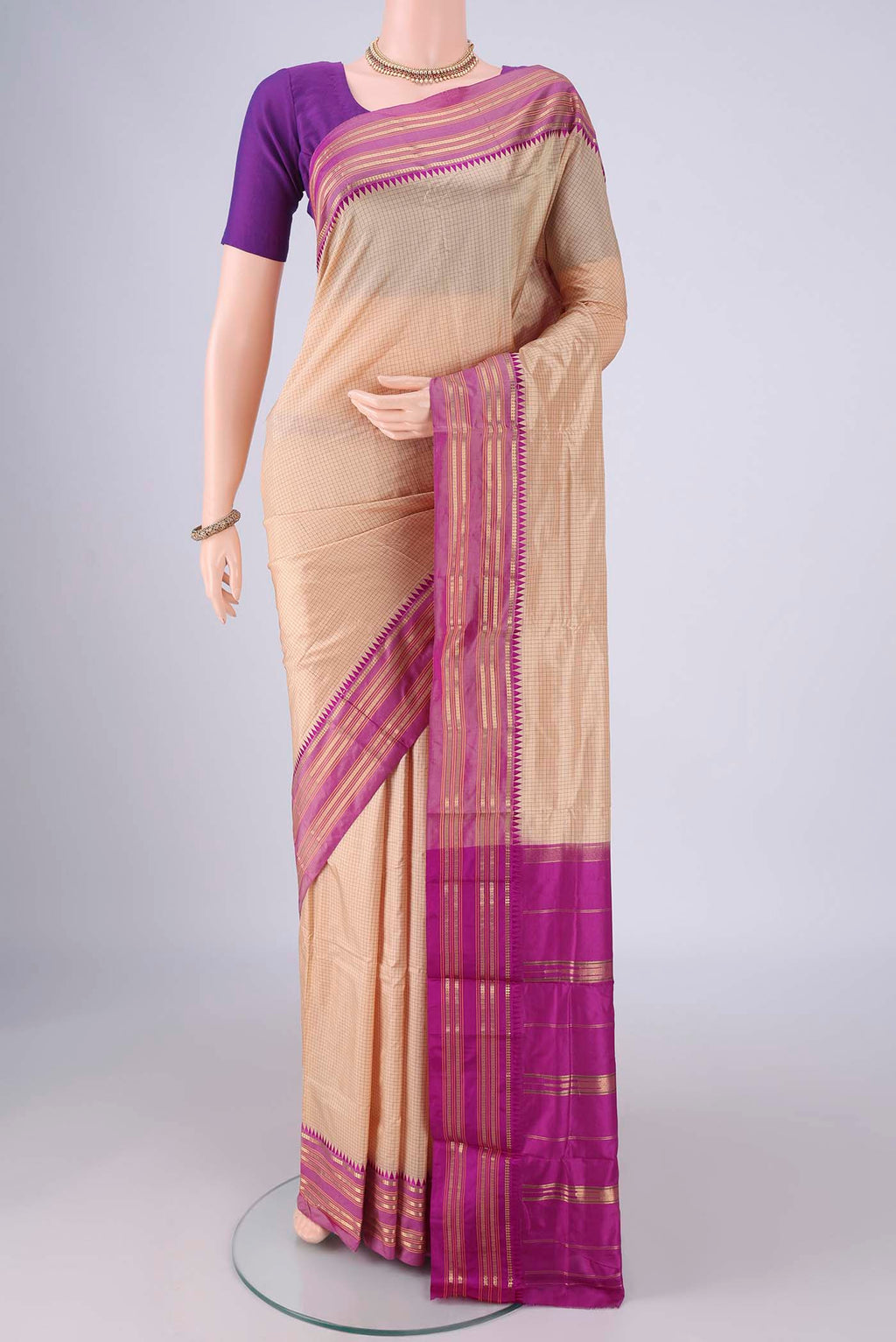 Beige Narayanpet Silk Saree with Checked design on the body and Temple Border.  displayed on a mannequin