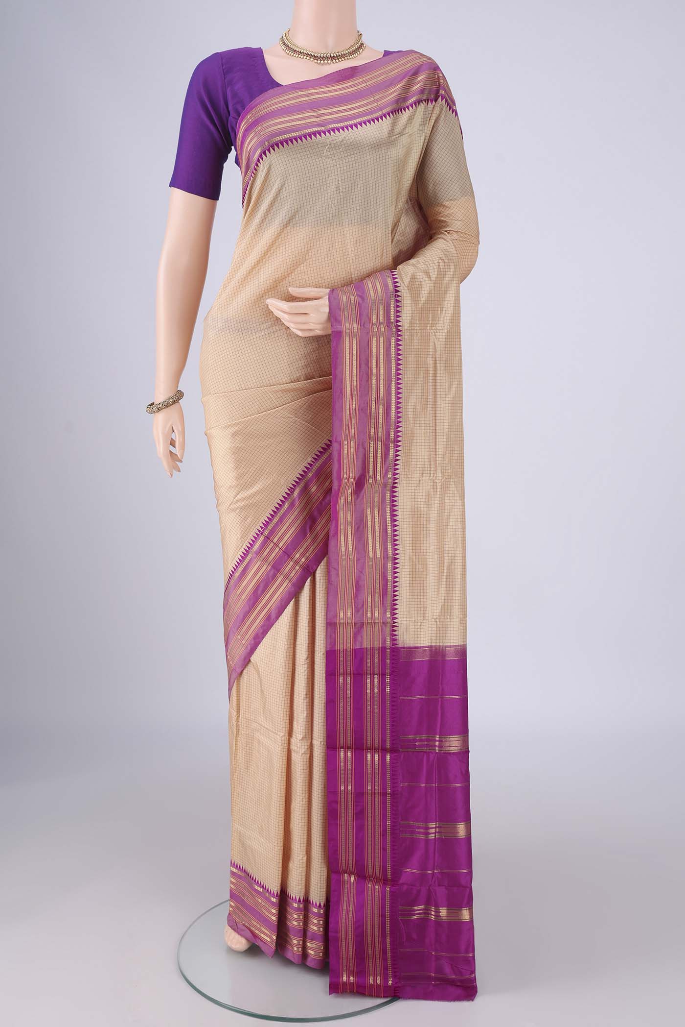 Beige Narayanpet Silk Saree with Checked design on the body and Temple Border.  displayed on a mannequin