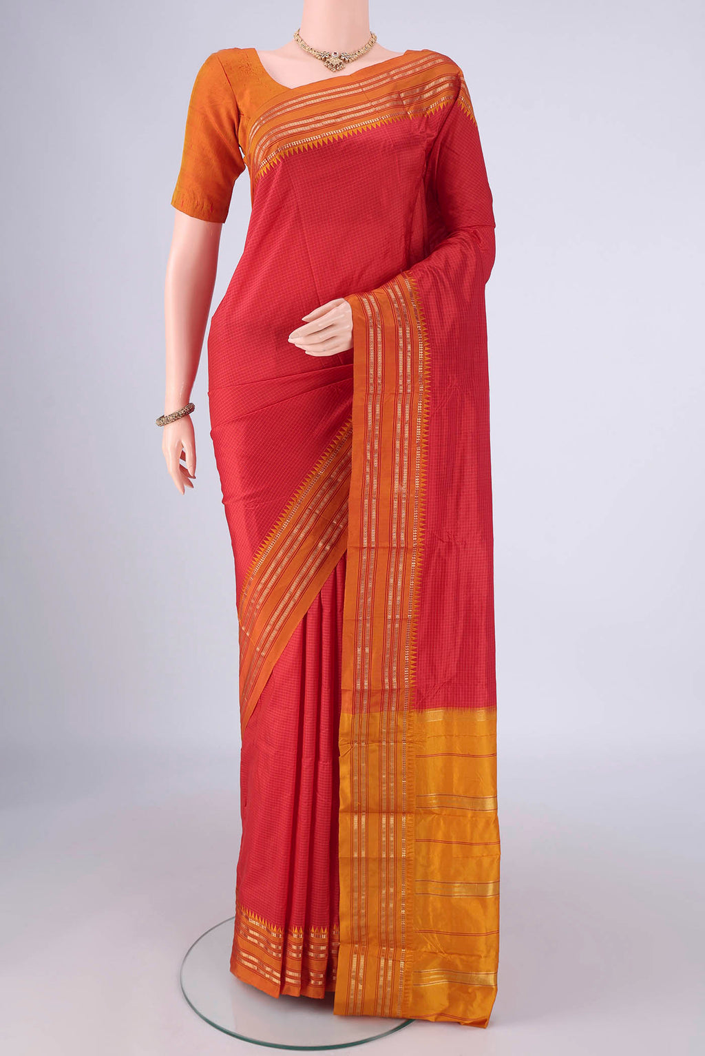 Red Narayanpet Silk Saree with Checked design on the body and Temple Border.  displayed on a mannequin