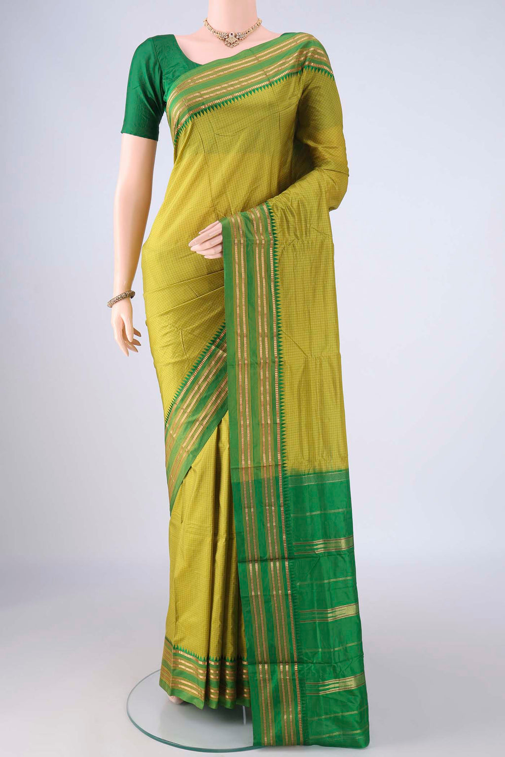 Light Green Narayanpet Silk Saree with Checked design on the body and Zari Border.  displayed on a mannequin
