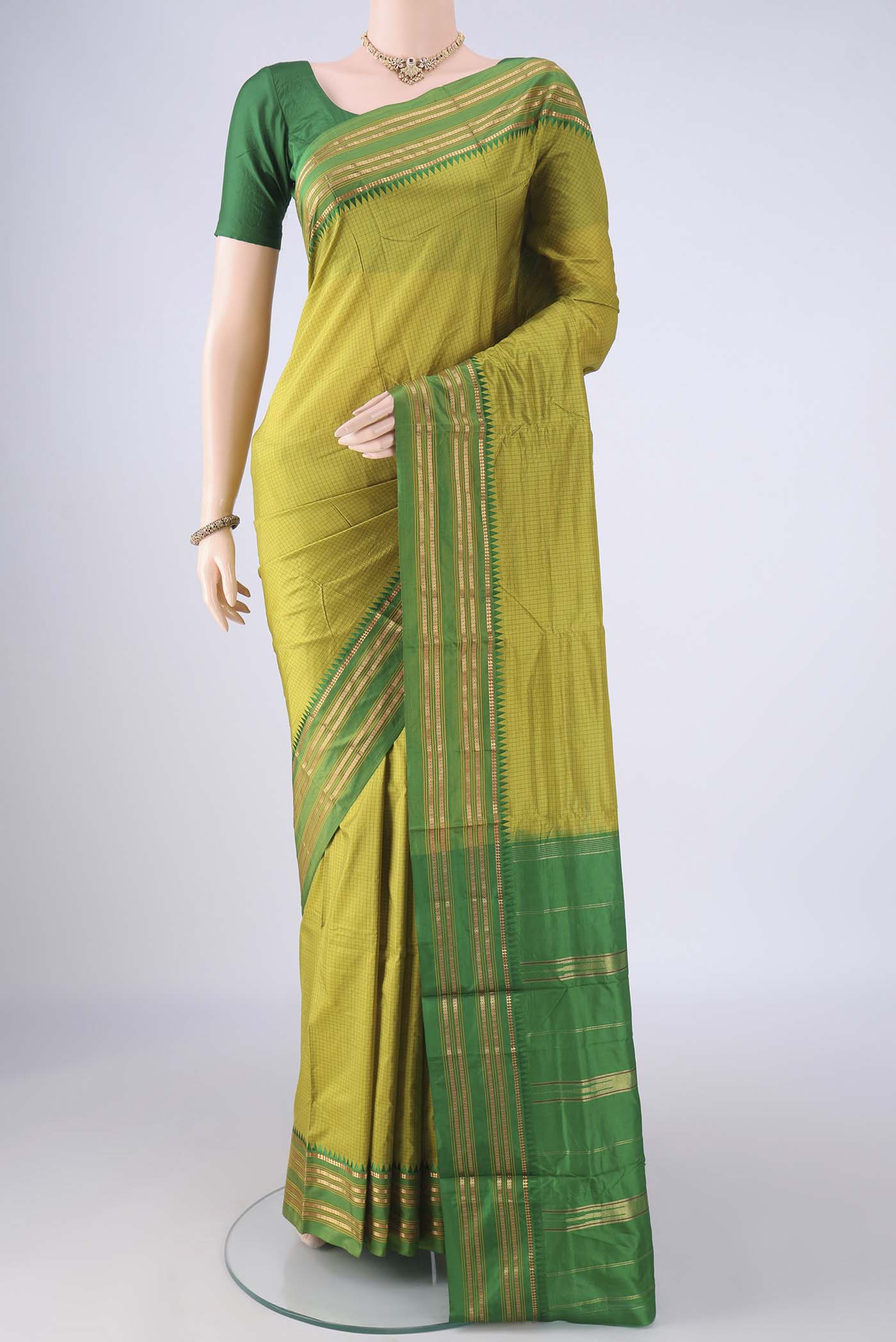 Light Green Narayanpet Silk Saree with Checked design on the body and Zari Border.  displayed on a mannequin