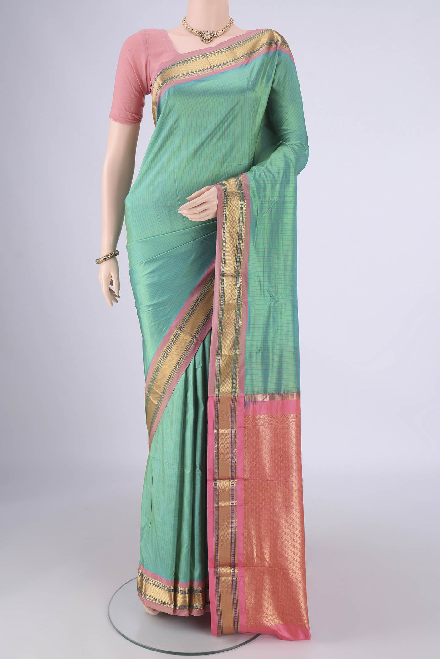 Sea Green Narayanpet Silk Saree with Checked design on the body and Zari Border.  displayed on a mannequin