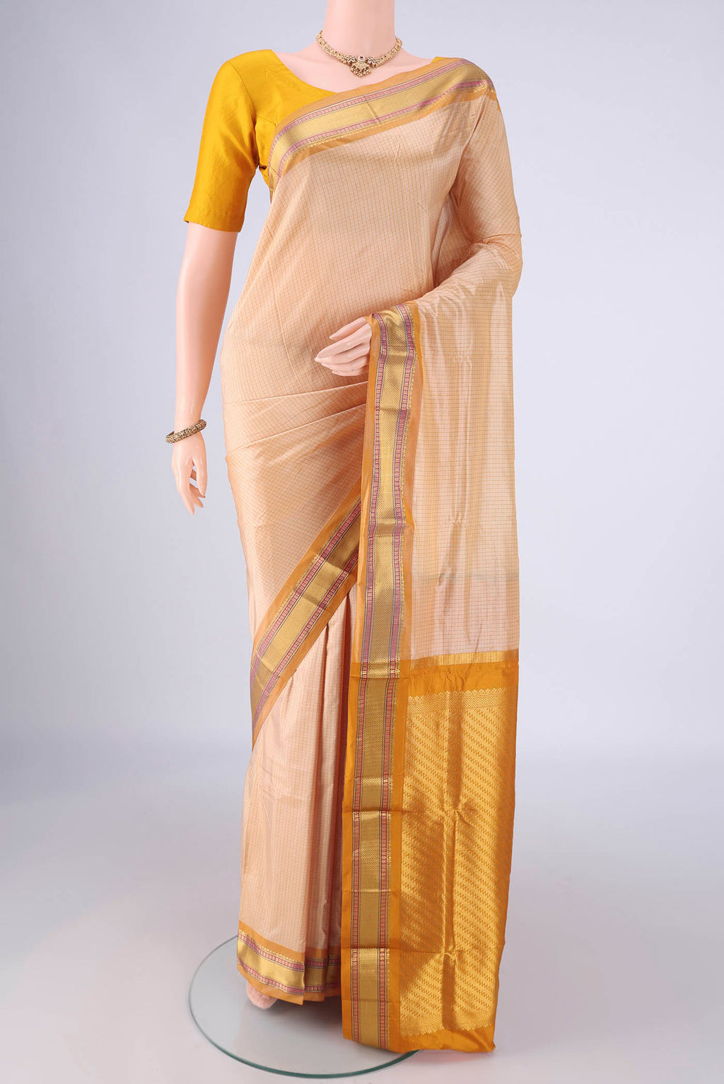 Cream Narayanpet Silk Saree with Checked design on the body and Zari Border.  displayed on a mannequin