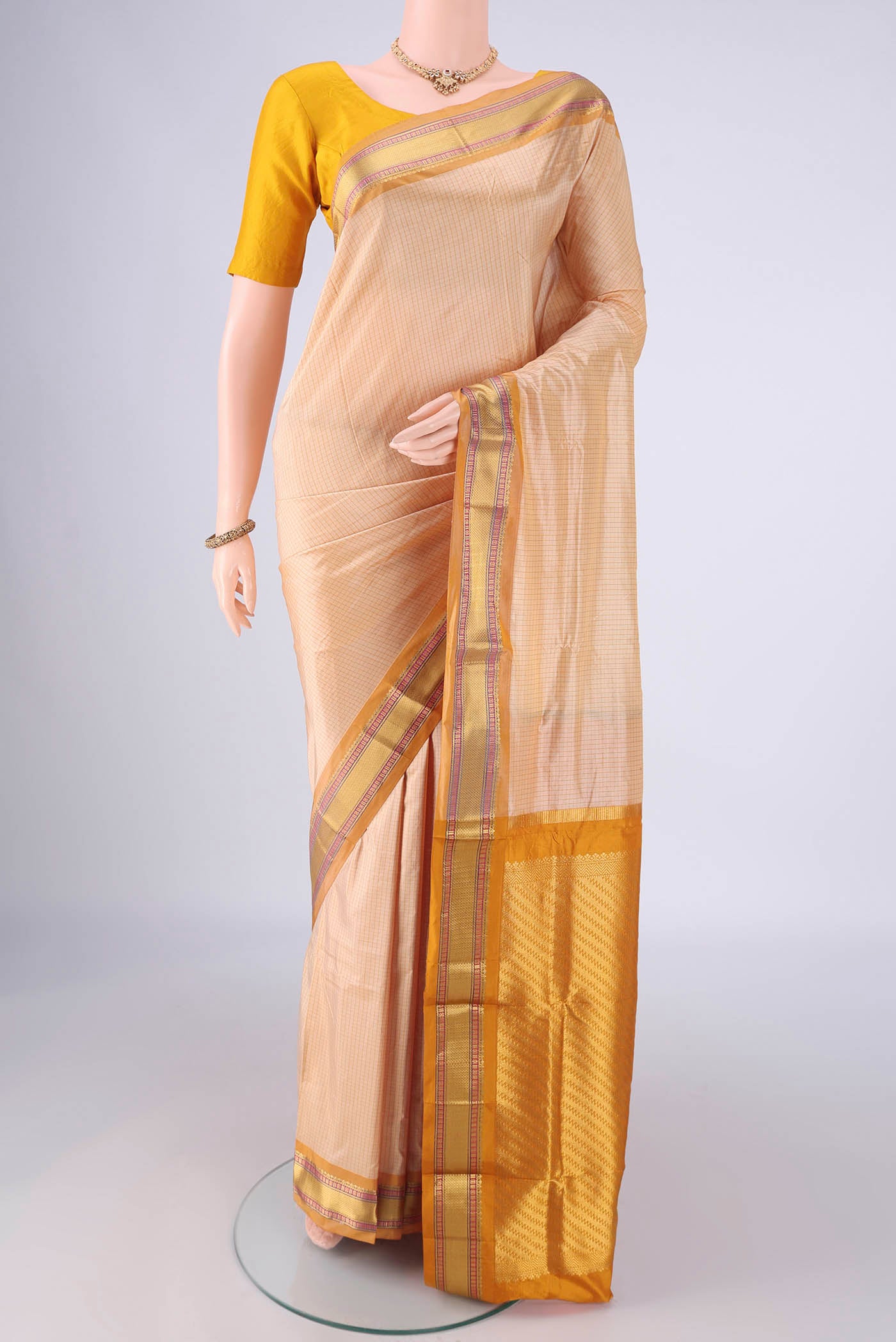 Cream Narayanpet Silk Saree with Checked design on the body and Zari Border.  displayed on a mannequin