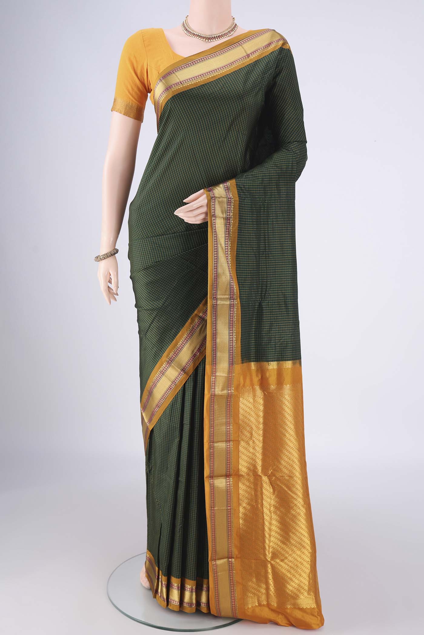 Bottle Green Narayanpet Silk Saree with Checked design on the body and Zari Border.  displayed on a mannequin