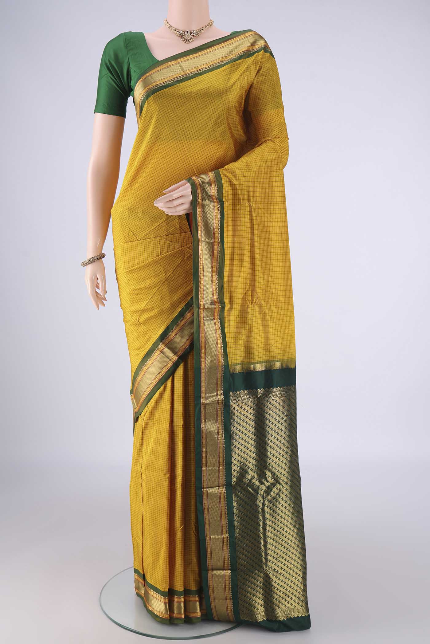 Yellow Narayanpet Silk Saree with Checked design on the body and Zari Border.  displayed on a mannequin